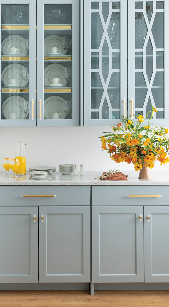 kitchen with light blue cabinets and orange flowers