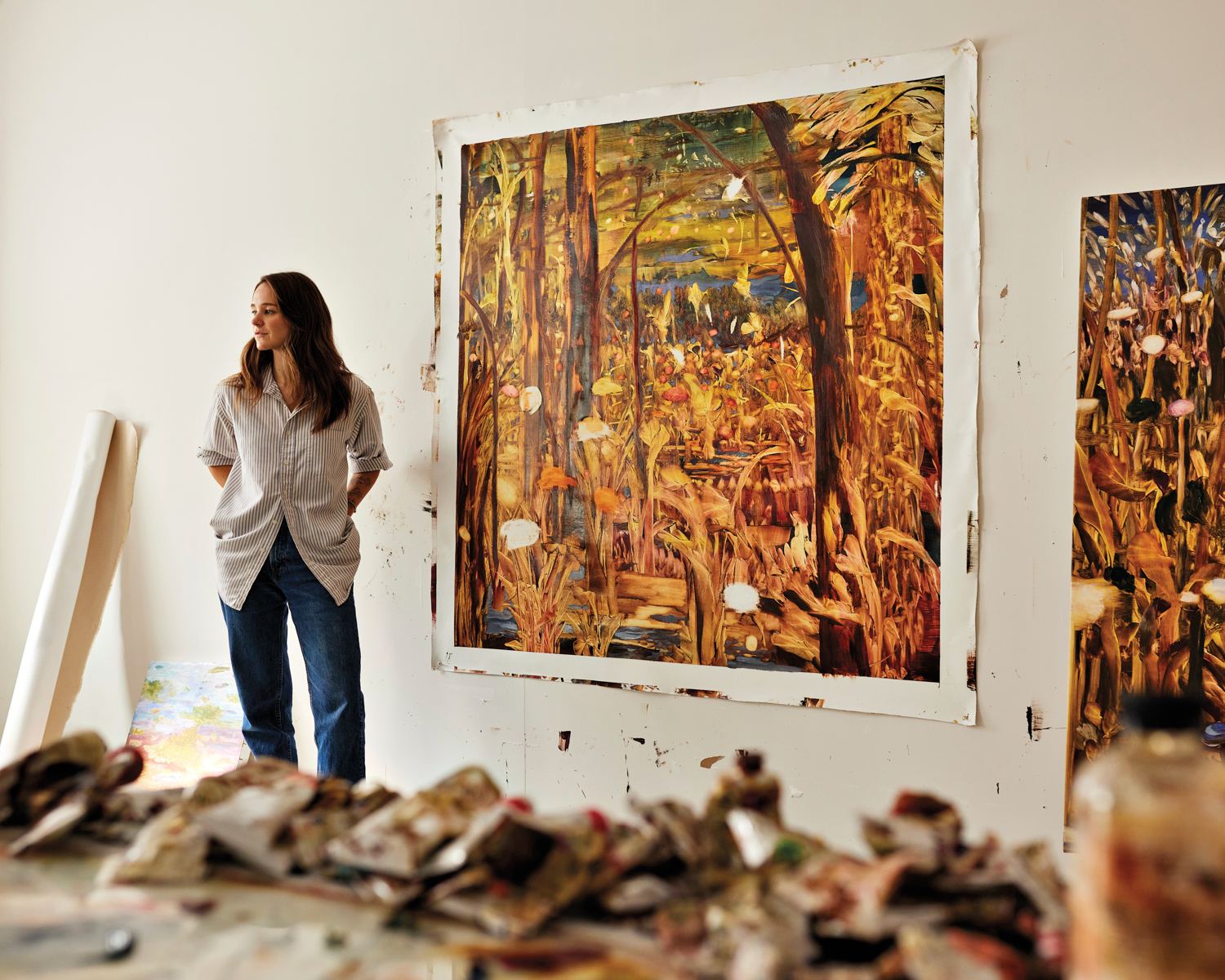 Artist Madeline Peckenpaugh with some of her paintings