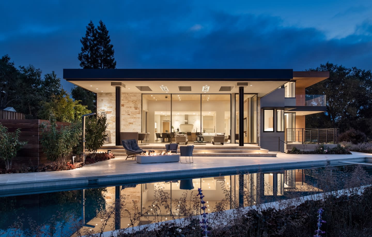 Contemporary home with pool and sleek fire pit built by Conrado Home Builders.