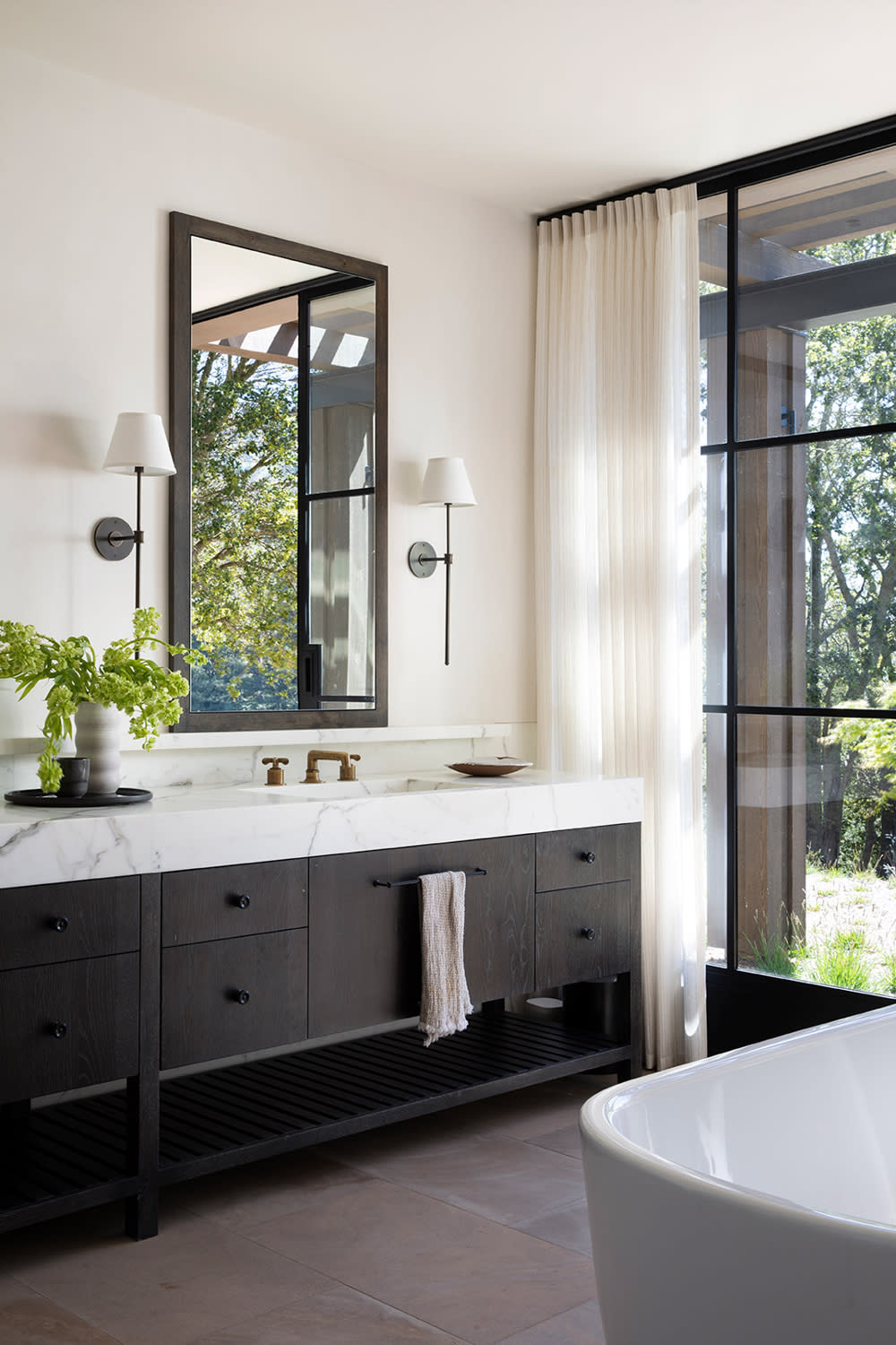 classic bathroom with a black vanity and white walls