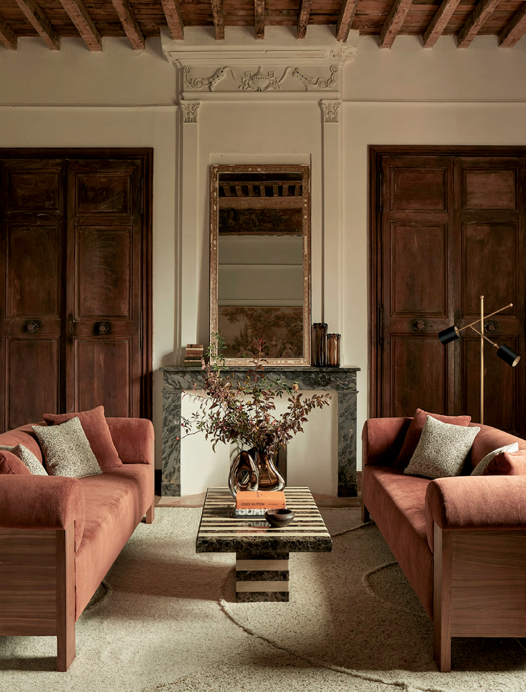 living room vignette with pink sofas topped with white and pink throw pillows