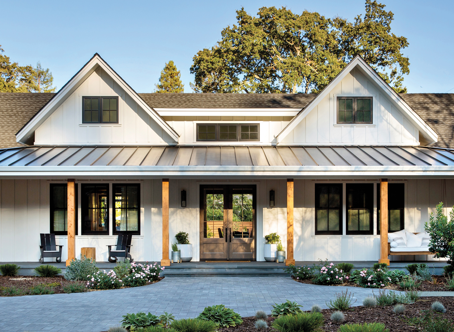 front of farmhouse style home with modern finishings by Sondra Ganz