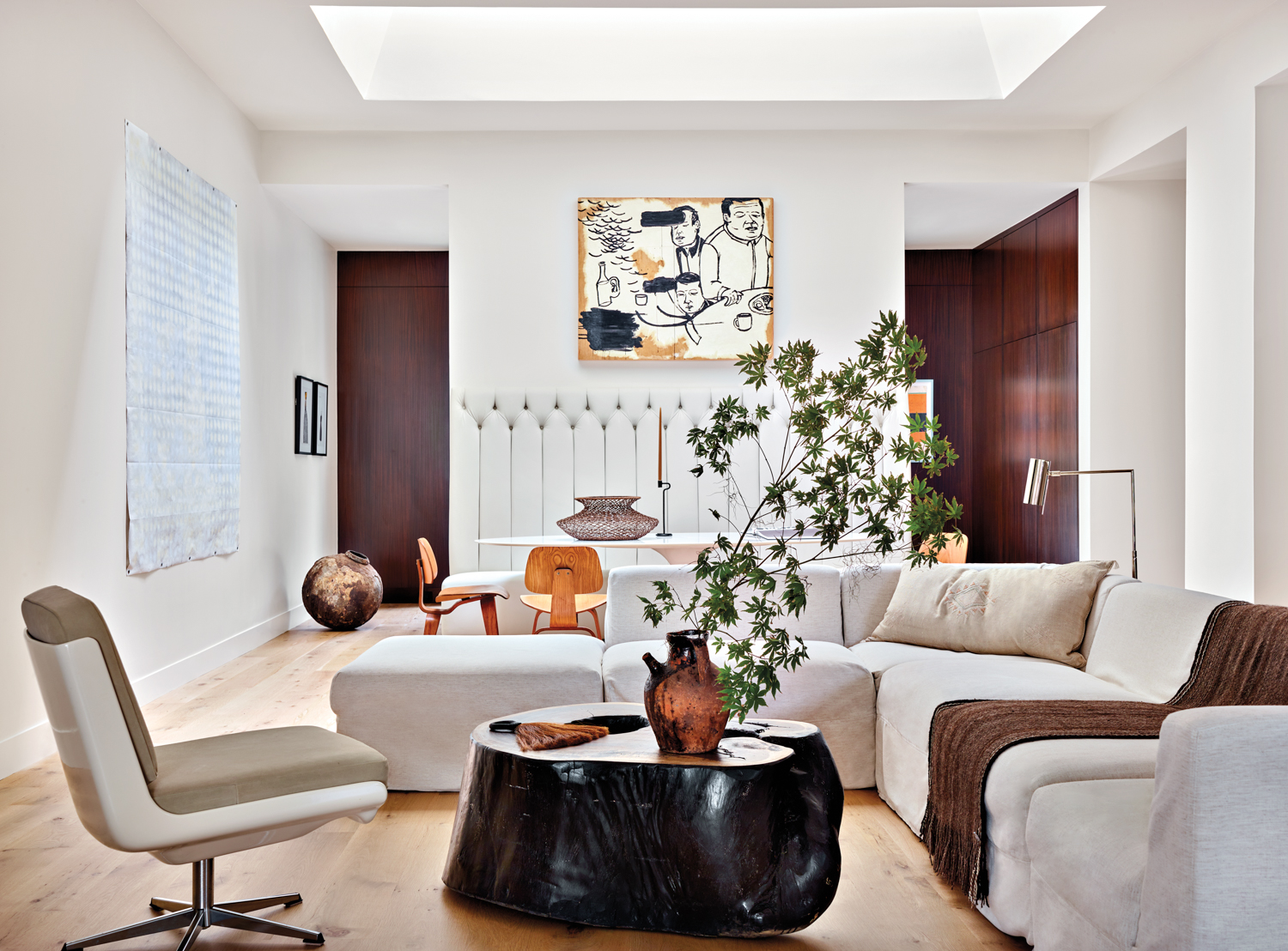 Open-format living room with cream-colored upholstery and large skylight