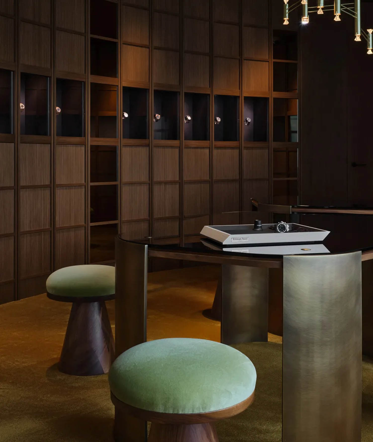 watchmaker's studio with green stools next to a working table