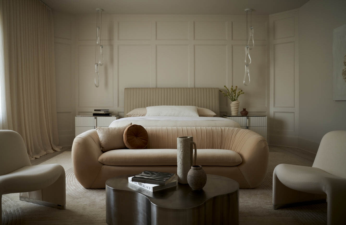 contemporary bedroom in taupe shades featuring sculptural pendants