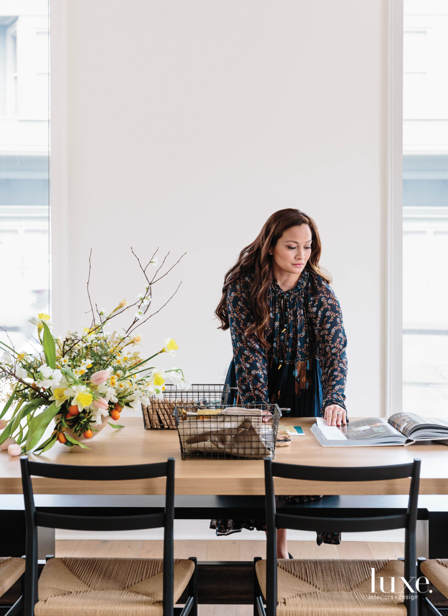 Designer Tracy Simmons arranges items on a table in her store, The House