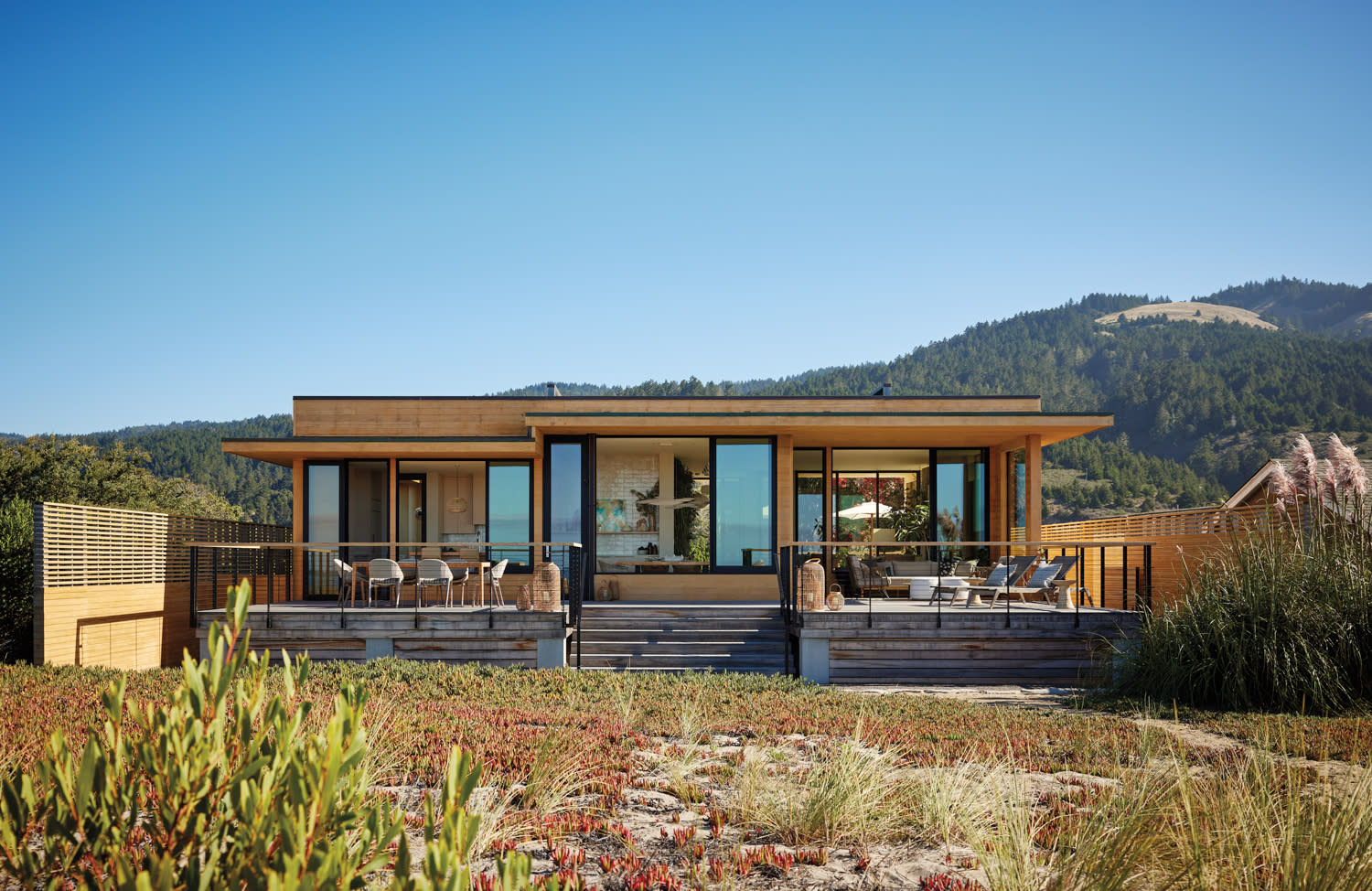 A beach house by Susan Skornicka sits between mountains and sand