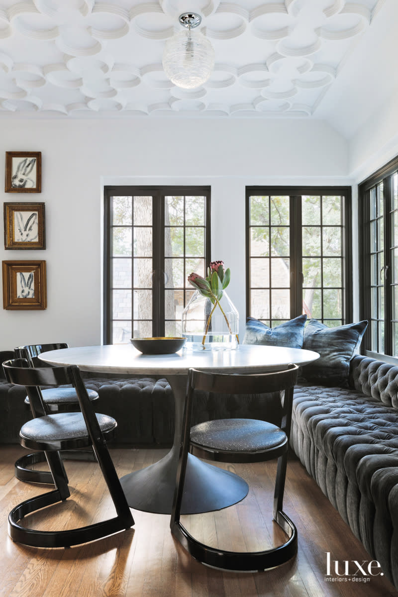 The dining area has a velvet banquette and a quatrefoil ceiling.