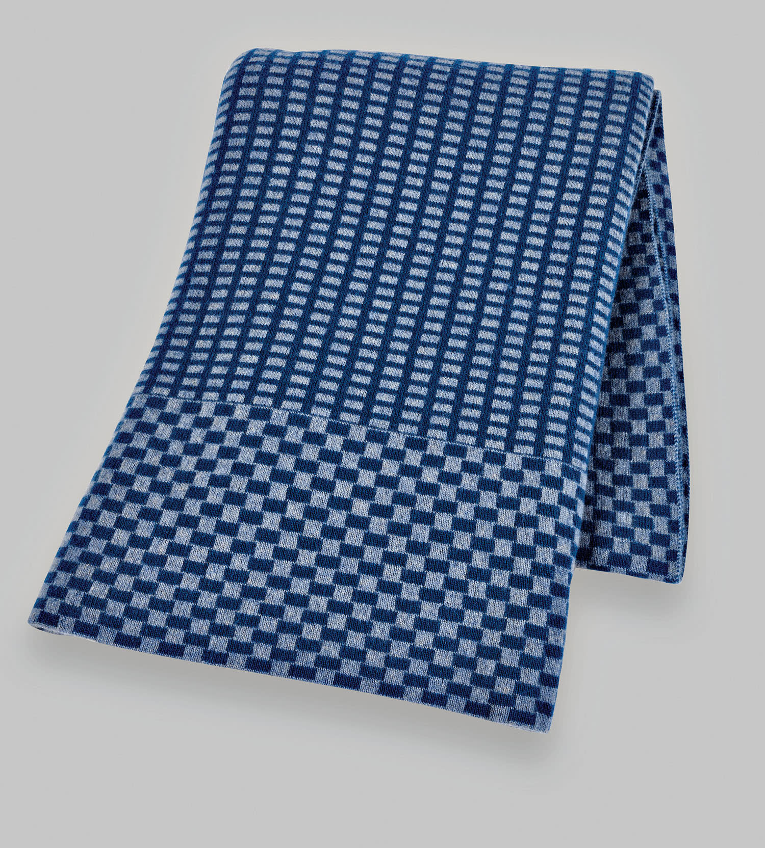A blue patterned cashmere throw blanket.
