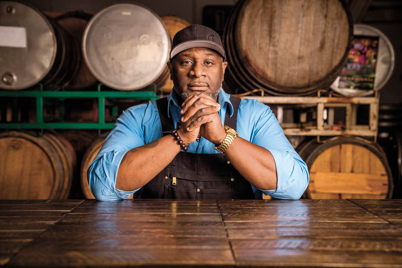 Winemaker portrait in front of wine barrels