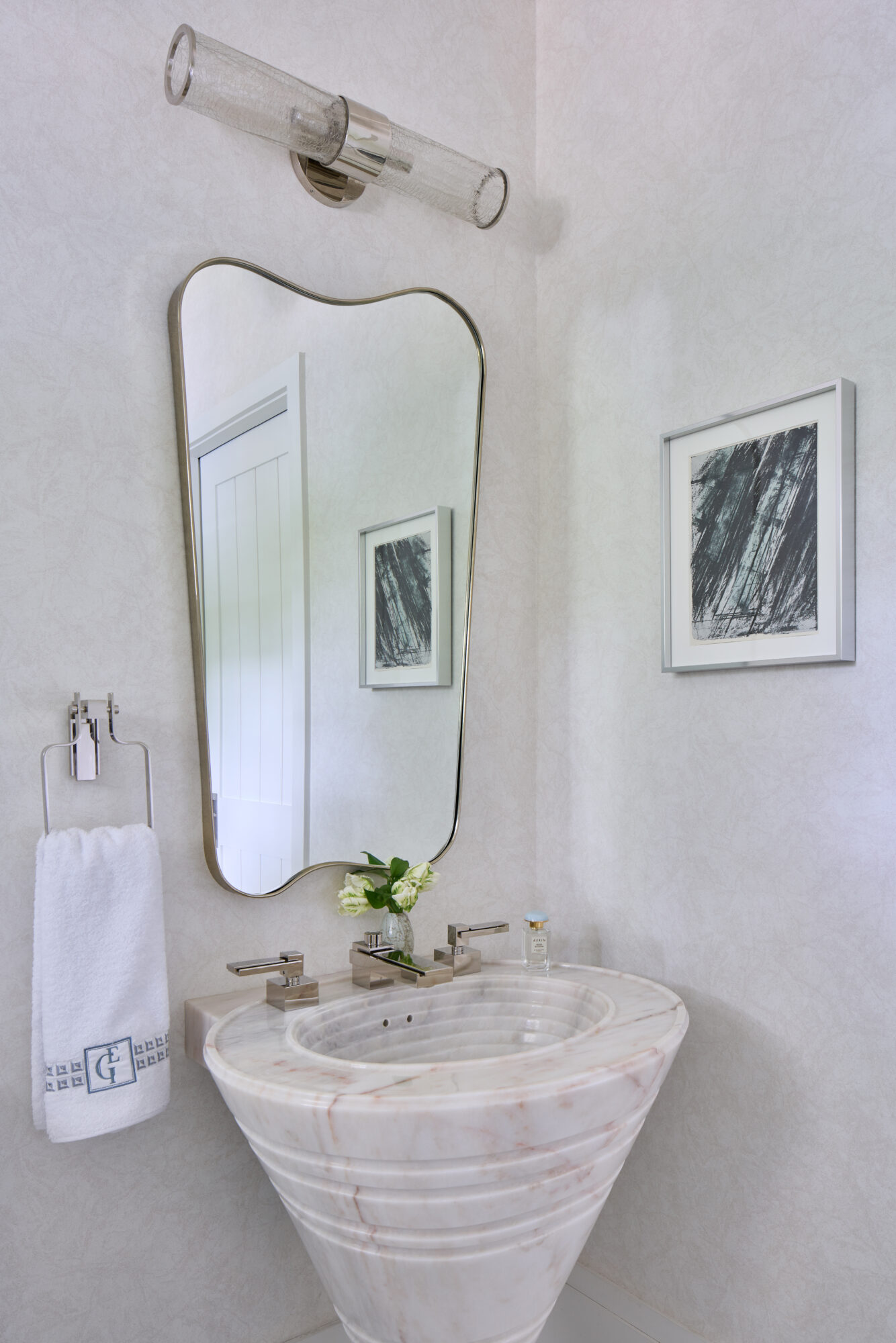 organic shaped curved bathroom mirror and stone sink Elizabeth gill interiors