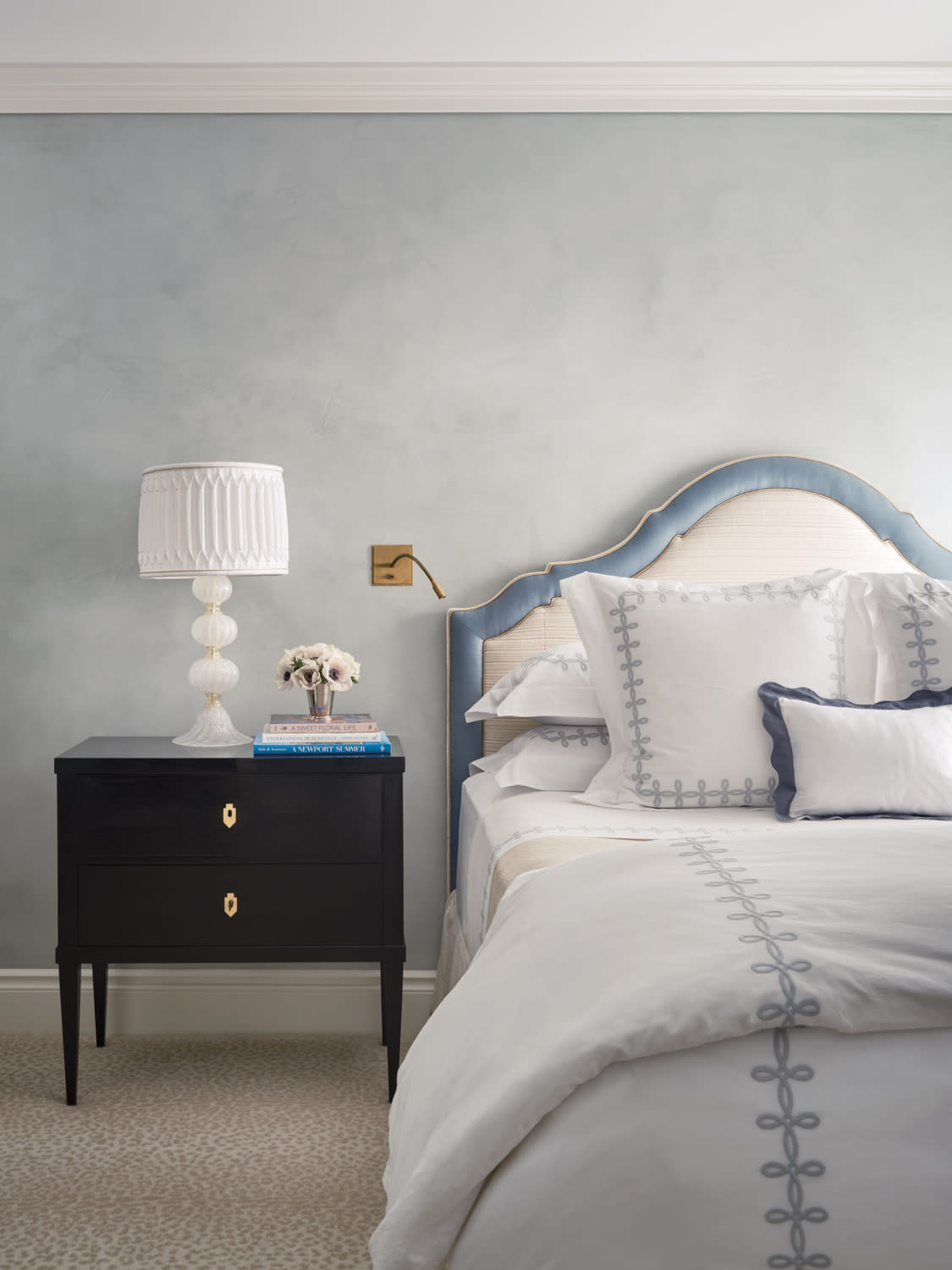 light blue bedroom with a jacquard headboard