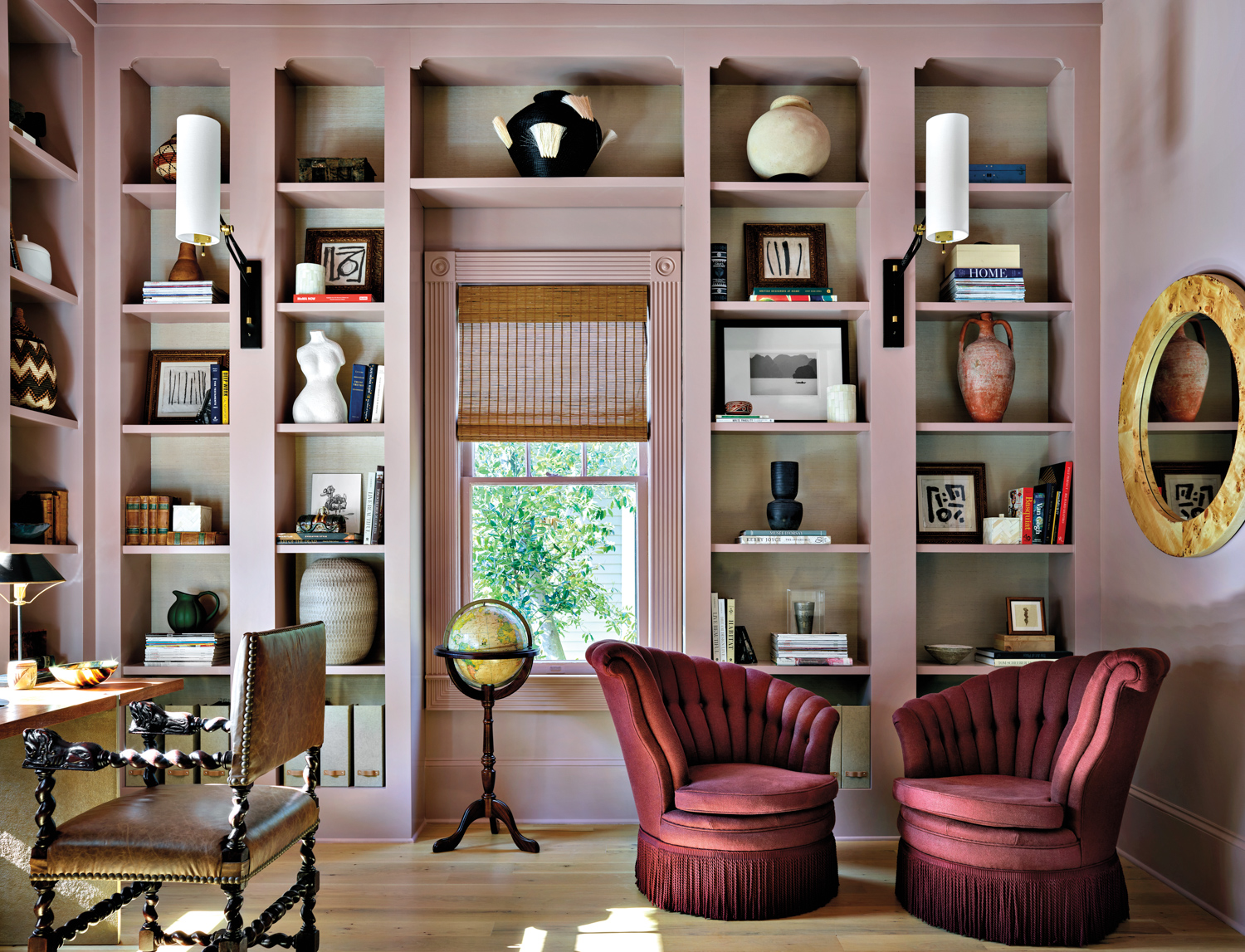 Library with floor-to-ceiling bookshelves painted pink