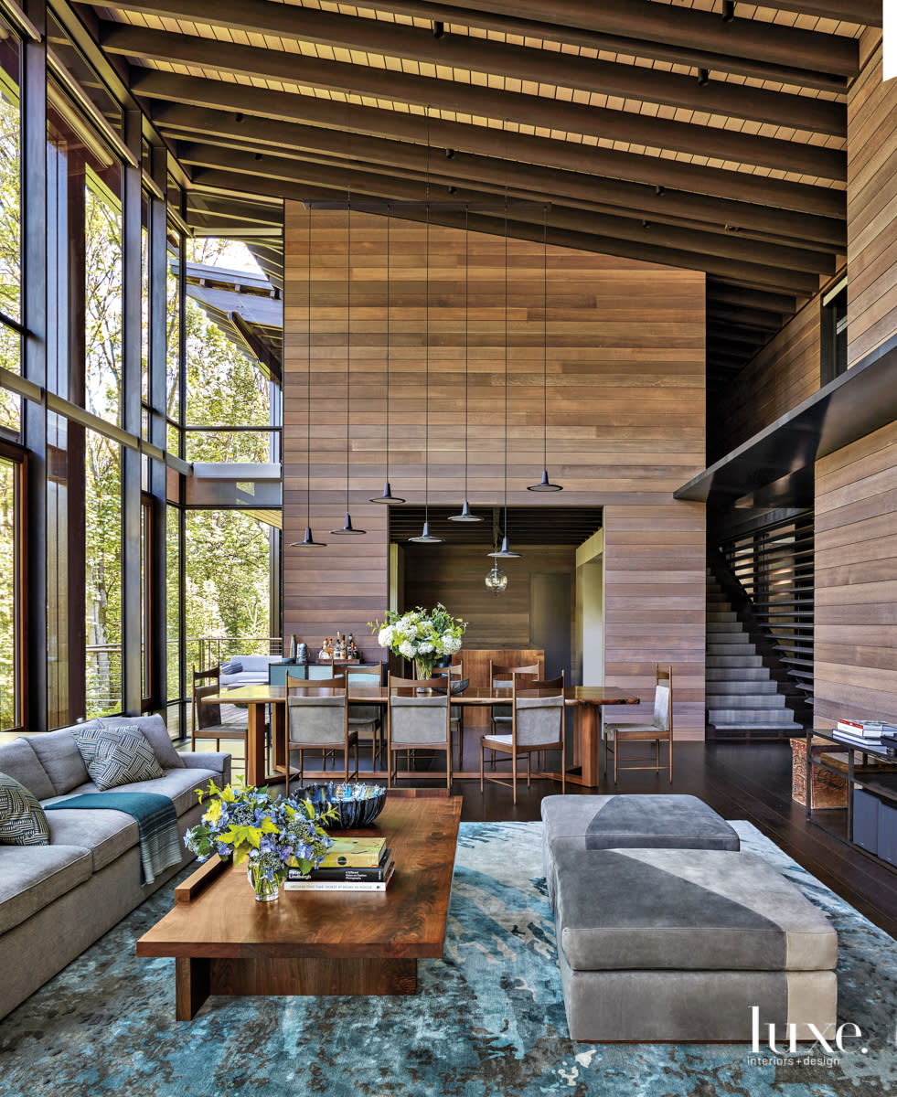 dining area and living area view with pendant lighting and window walls