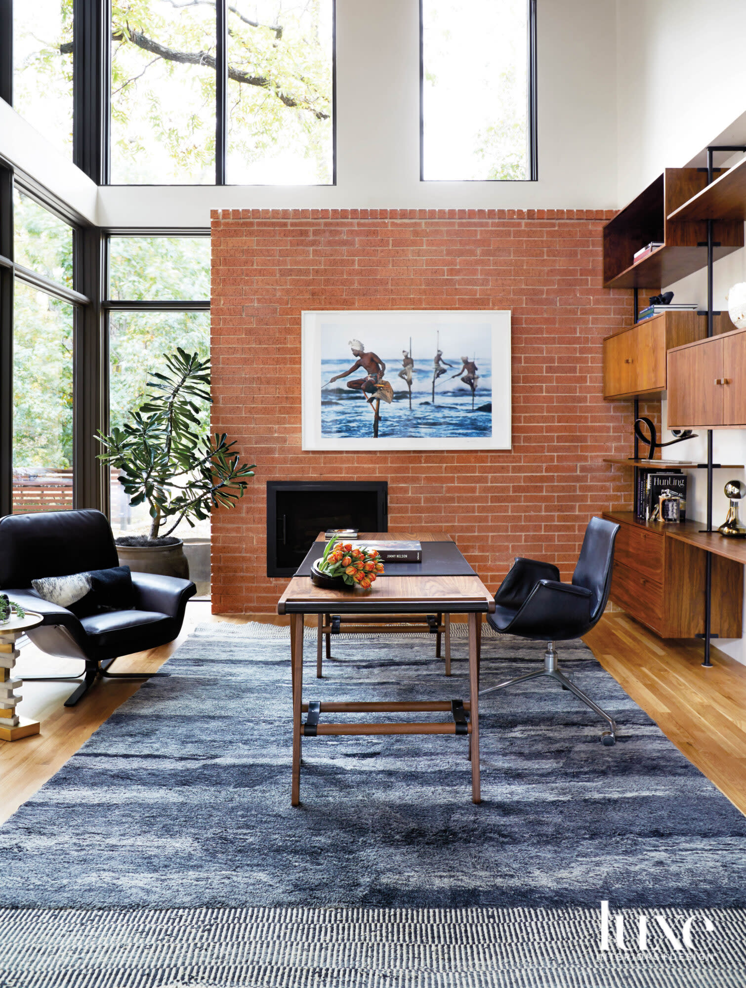 Study featuring Steve McCurry photography and midcentury modern-style furnishings.