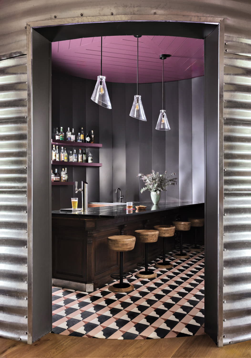 colorful home bar housed in a silo-inspired structure connecting the home's layout