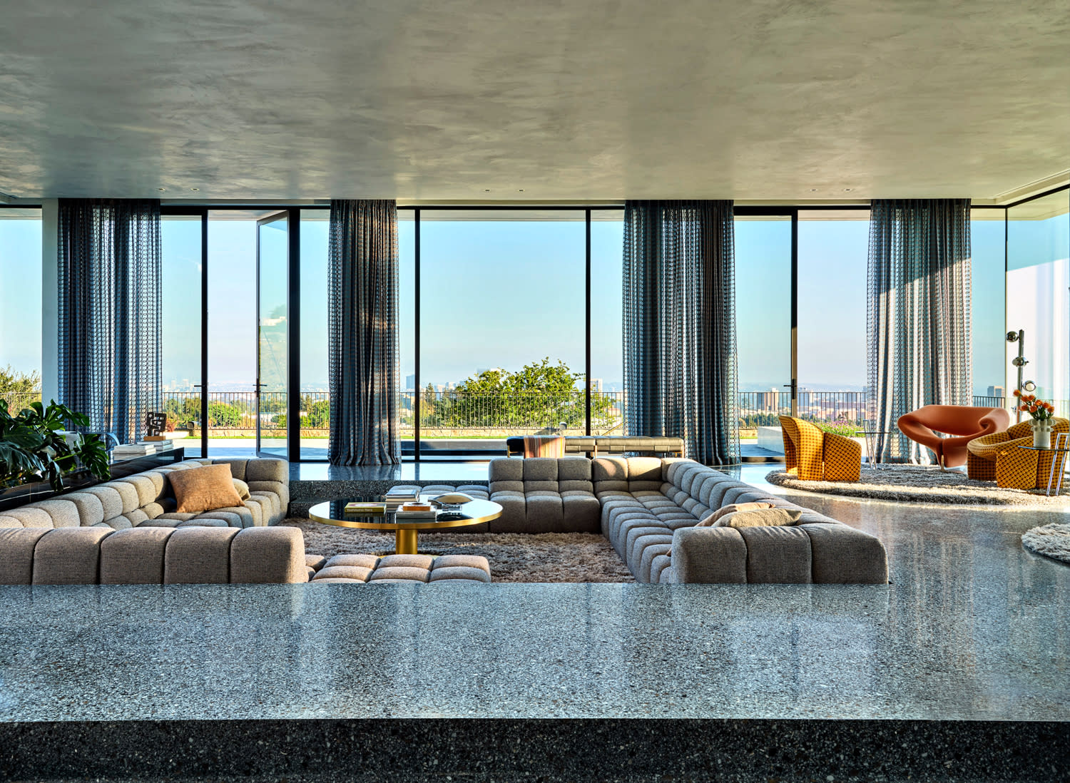 Spacious living room with large windows showcasing a scenic view.