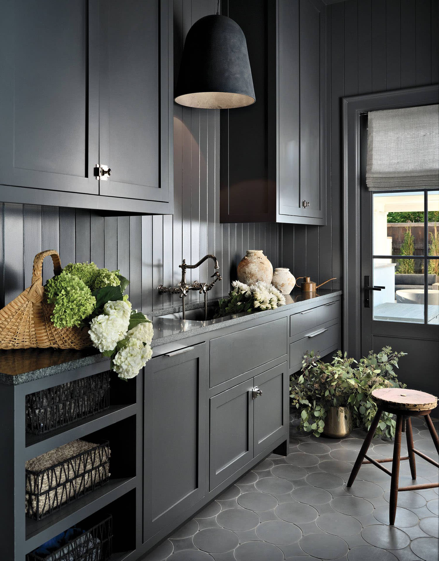 moody mudroom with black cabinetry 