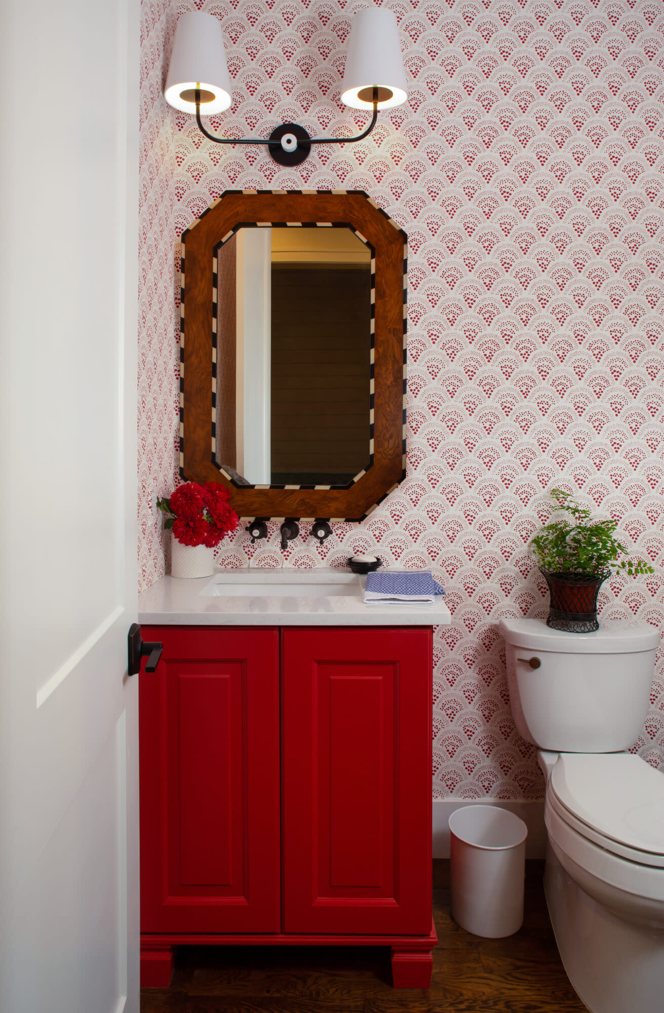 A powder room is done in red and white shades.