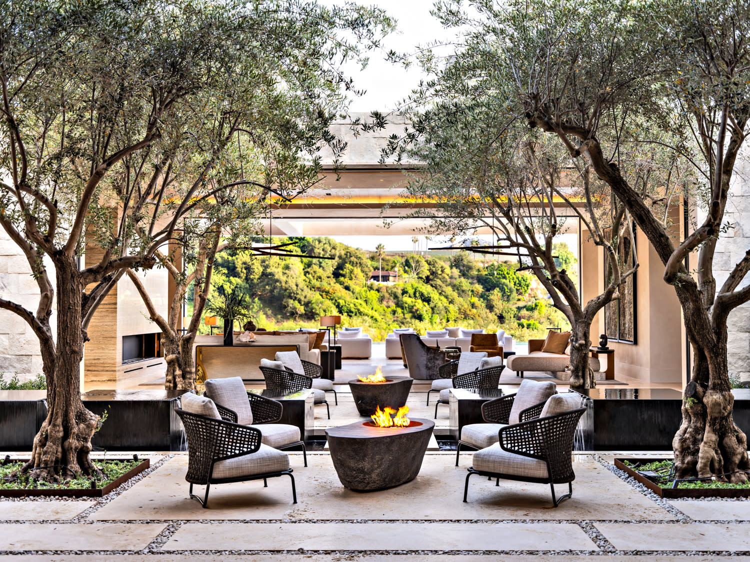 A cozy patio featuring several chairs arranged around a central fire pit, ideal for gatherings and relaxation.