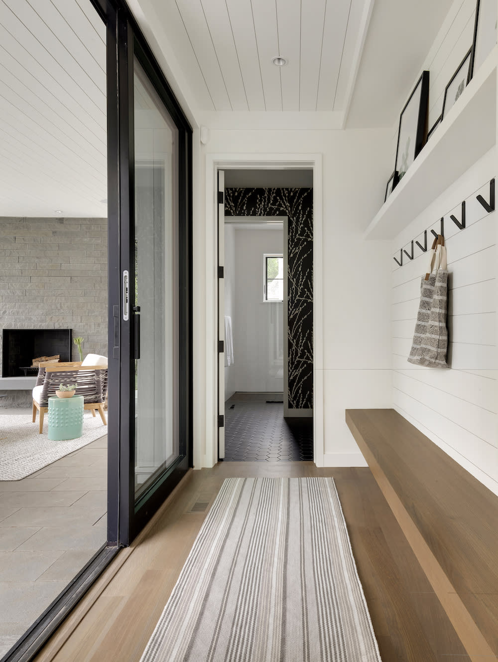 Entry hall with sliding glass doors and bench seating. 