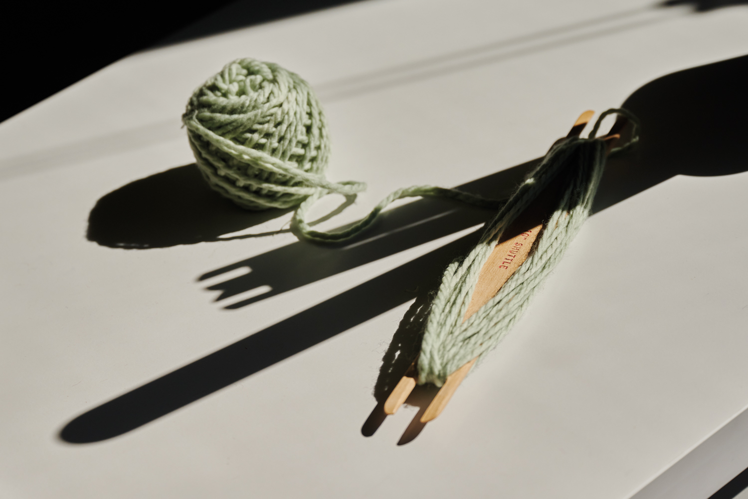 a stick shuttle and yarn