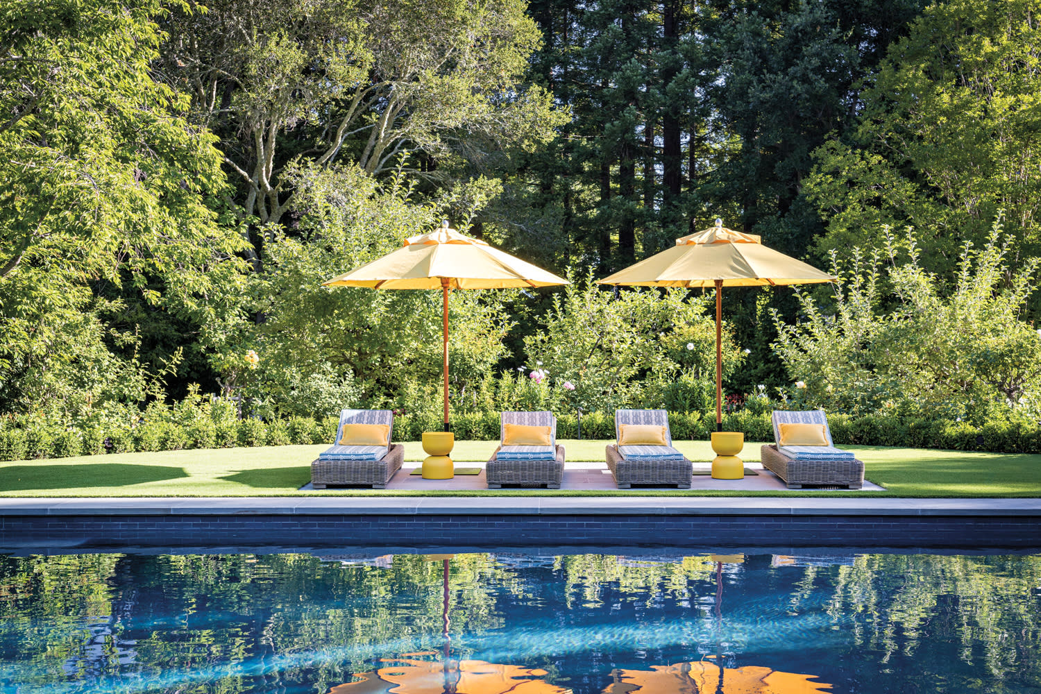 A serene pool area featuring colorful umbrellas and lounge chairs for relaxation.