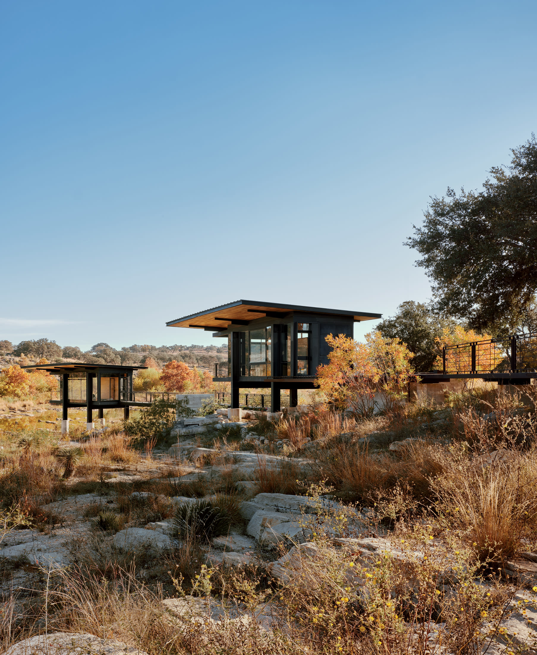 elevated outbuildings on a Texas property surrounded by natural landscaping