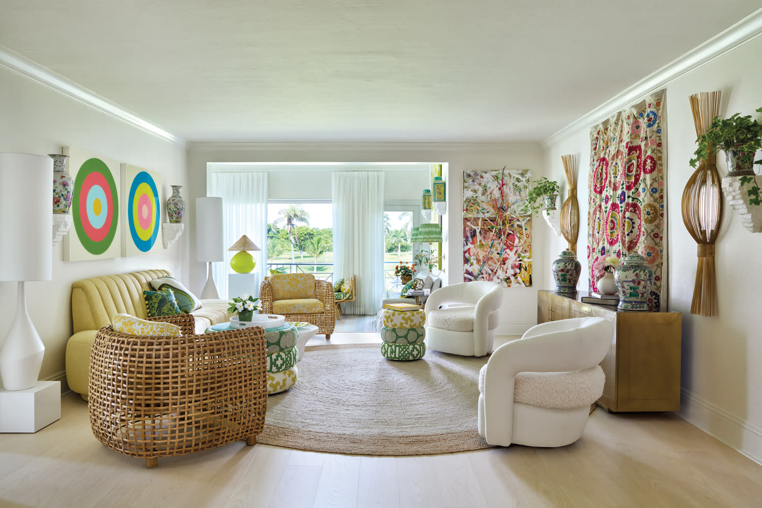 living room with tan settee, wicker chairs and coiled multicolored cloth coffee tables