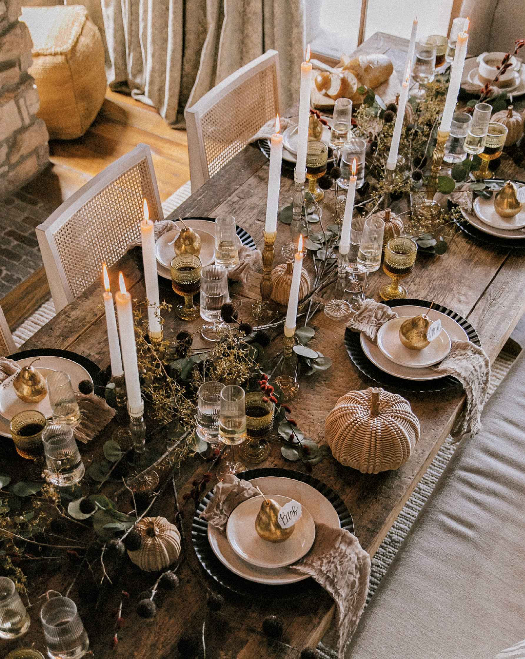 fall-inspired tablescape with greenery and tall tapered candles