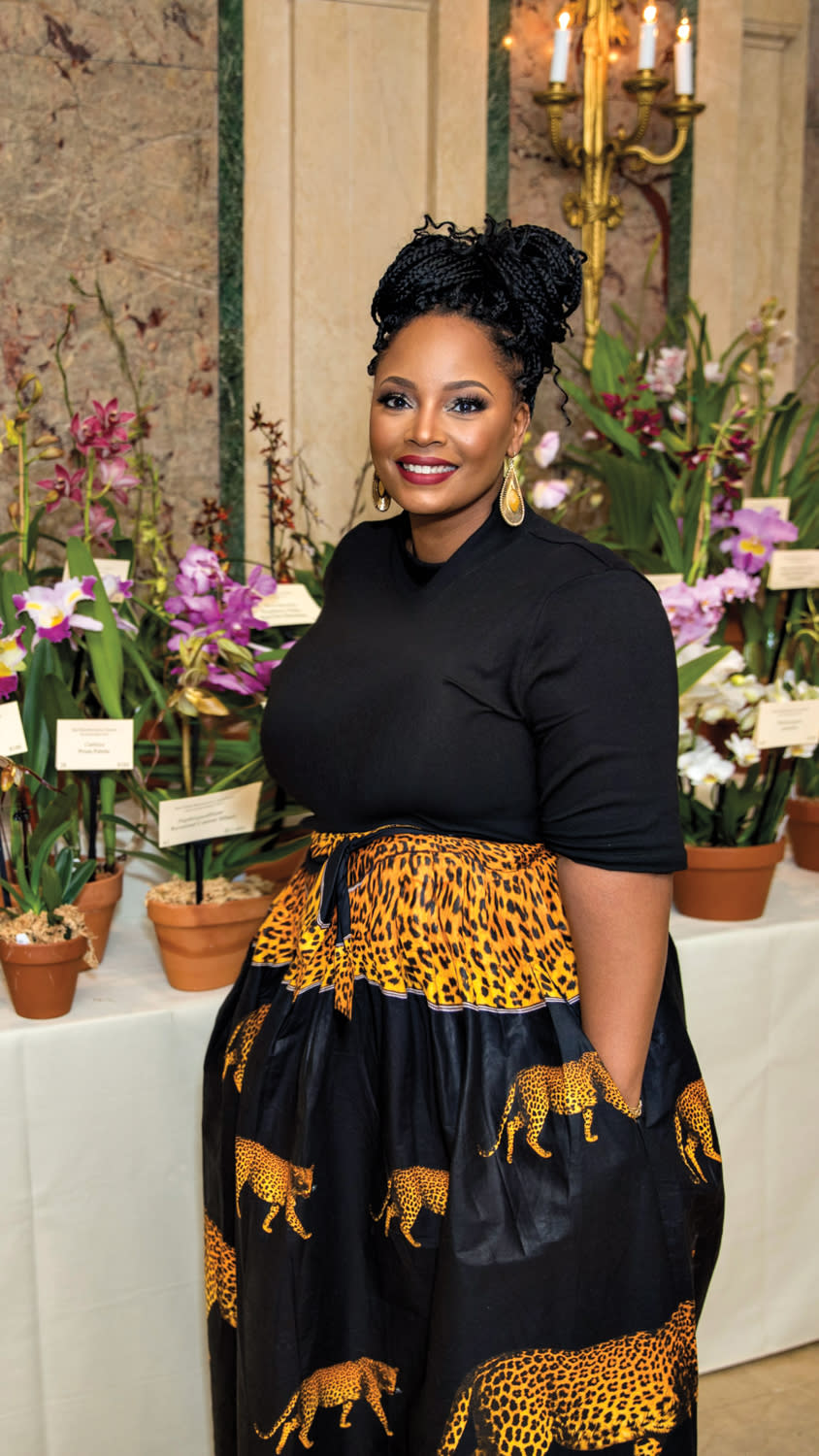 Designer Joy Williams posing by plants