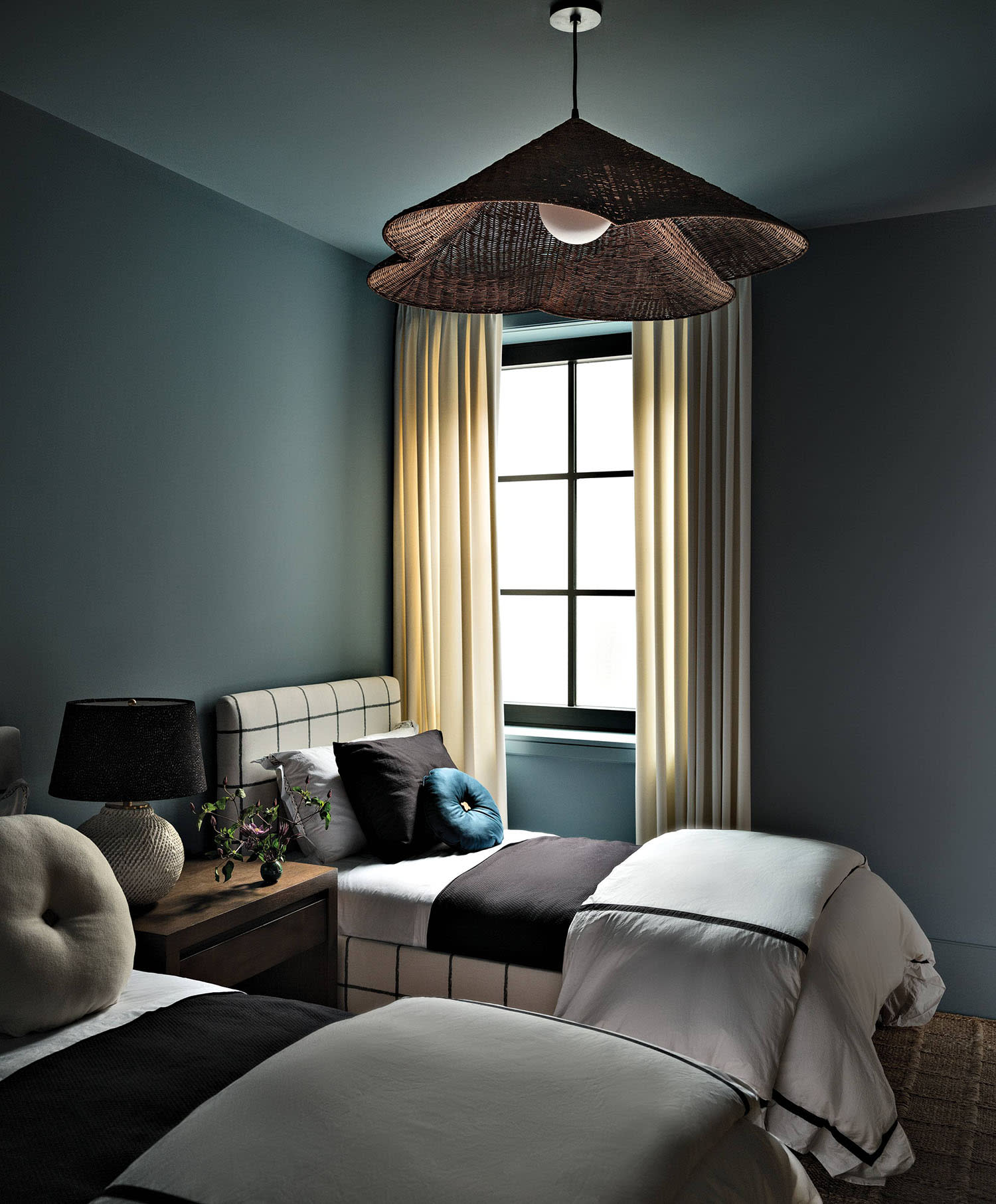 blue guest room with twin beds in matching linens