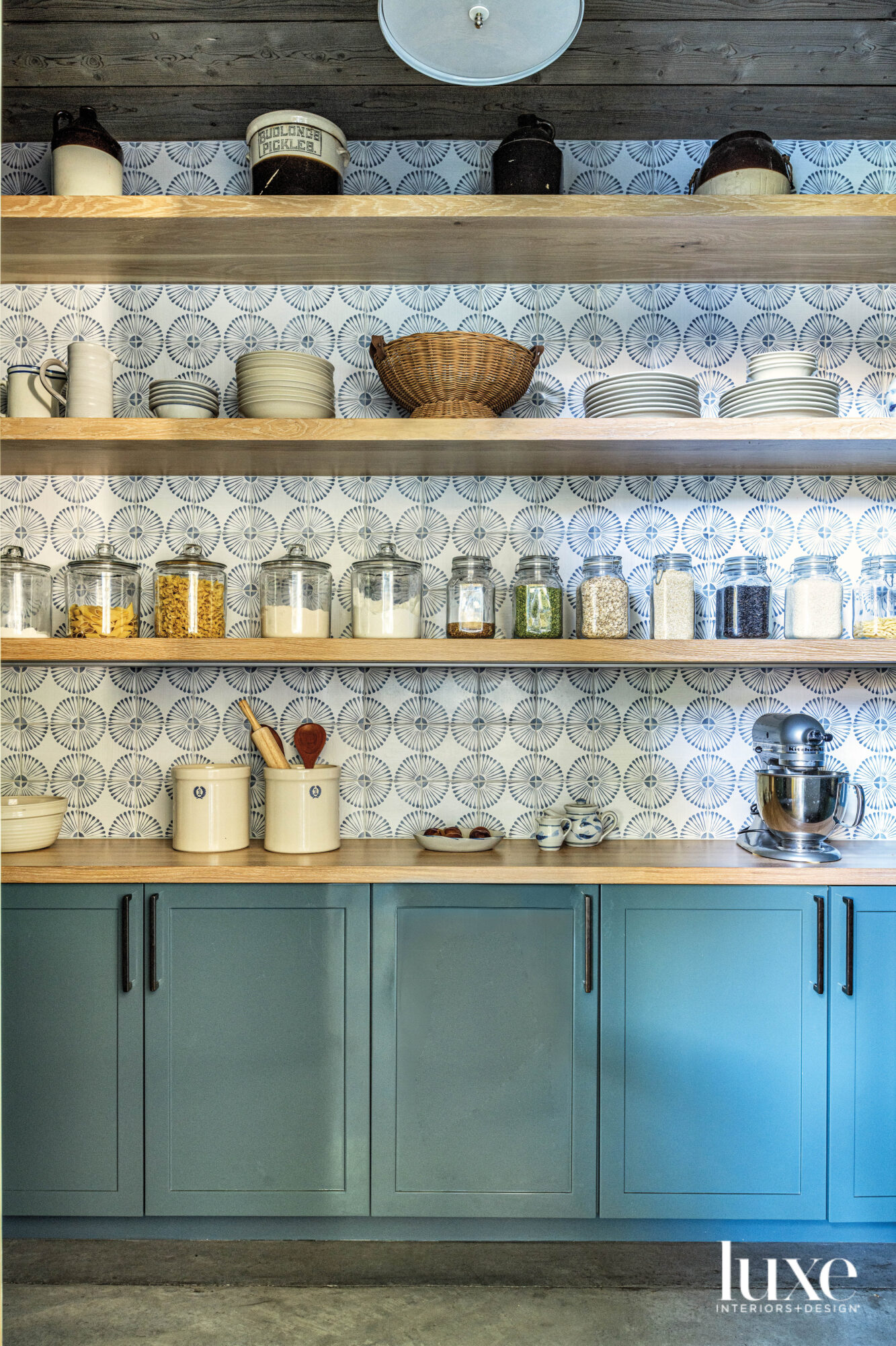 Pantry with tiled back and blue painted lower cabinets