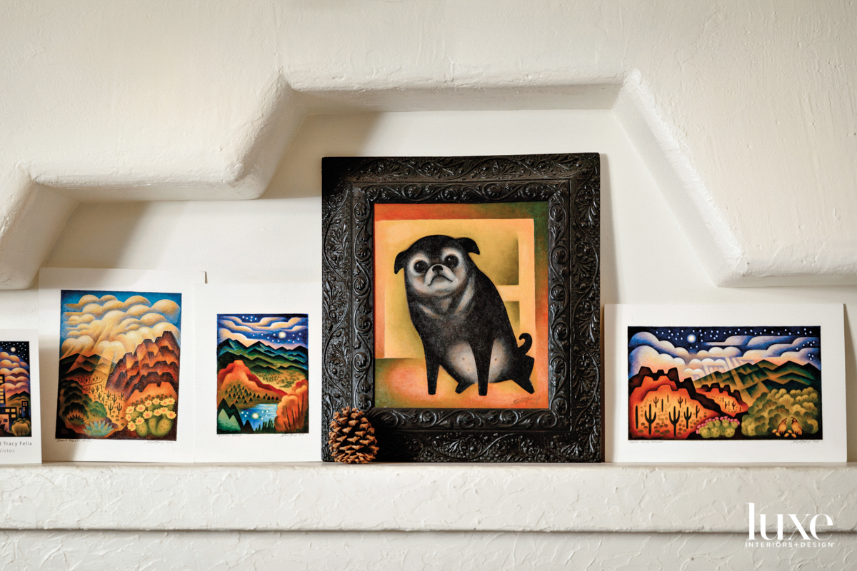 A painting shows a small, black dog.