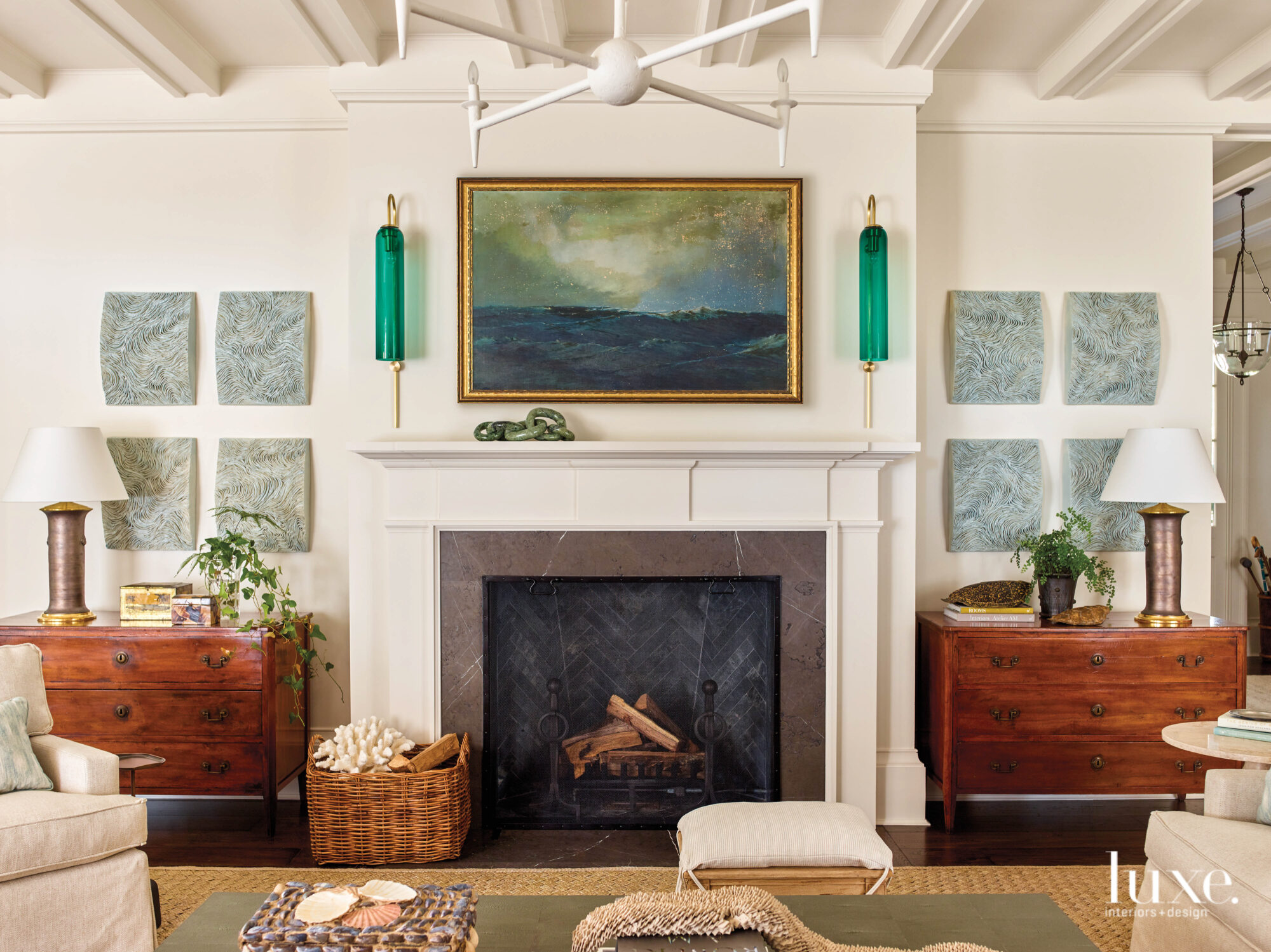 Fireplace with green sconces and brown wood chests on either side