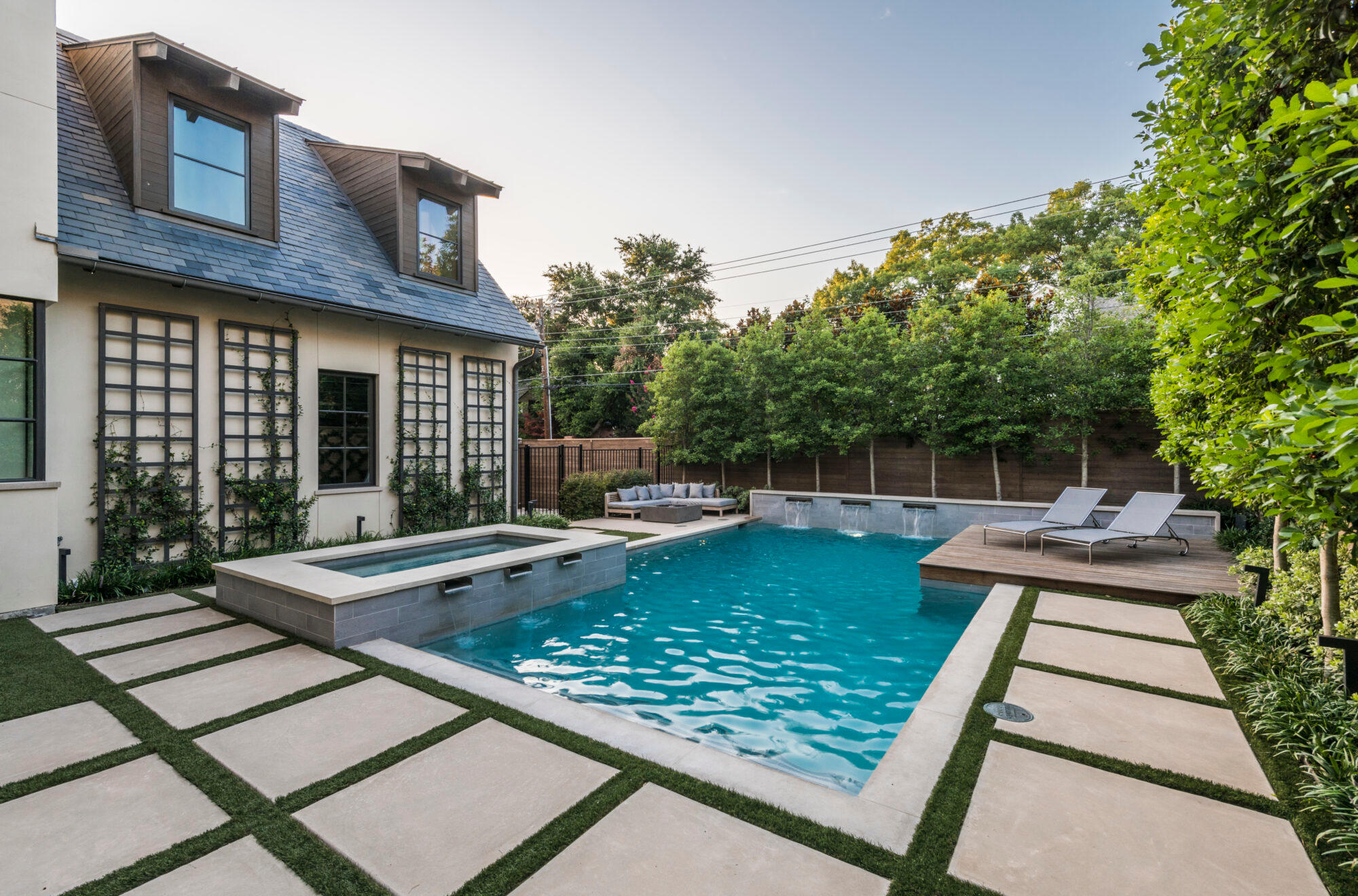 Classic-style backyard pool with geometric stone pavers