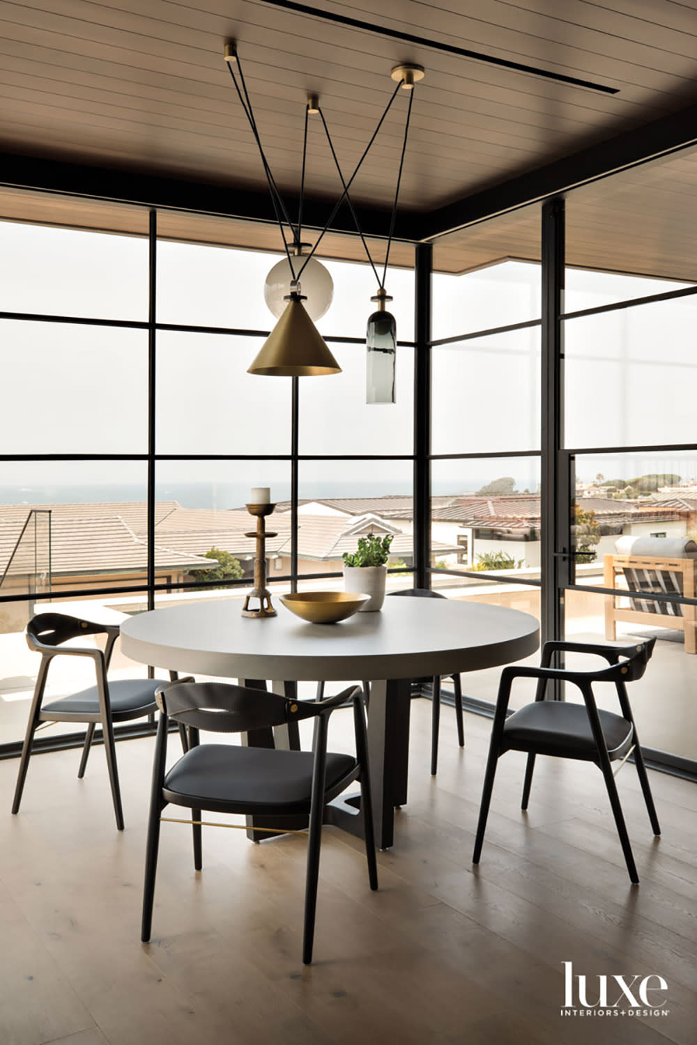 modern breakfast area surrounded by windows and beach views