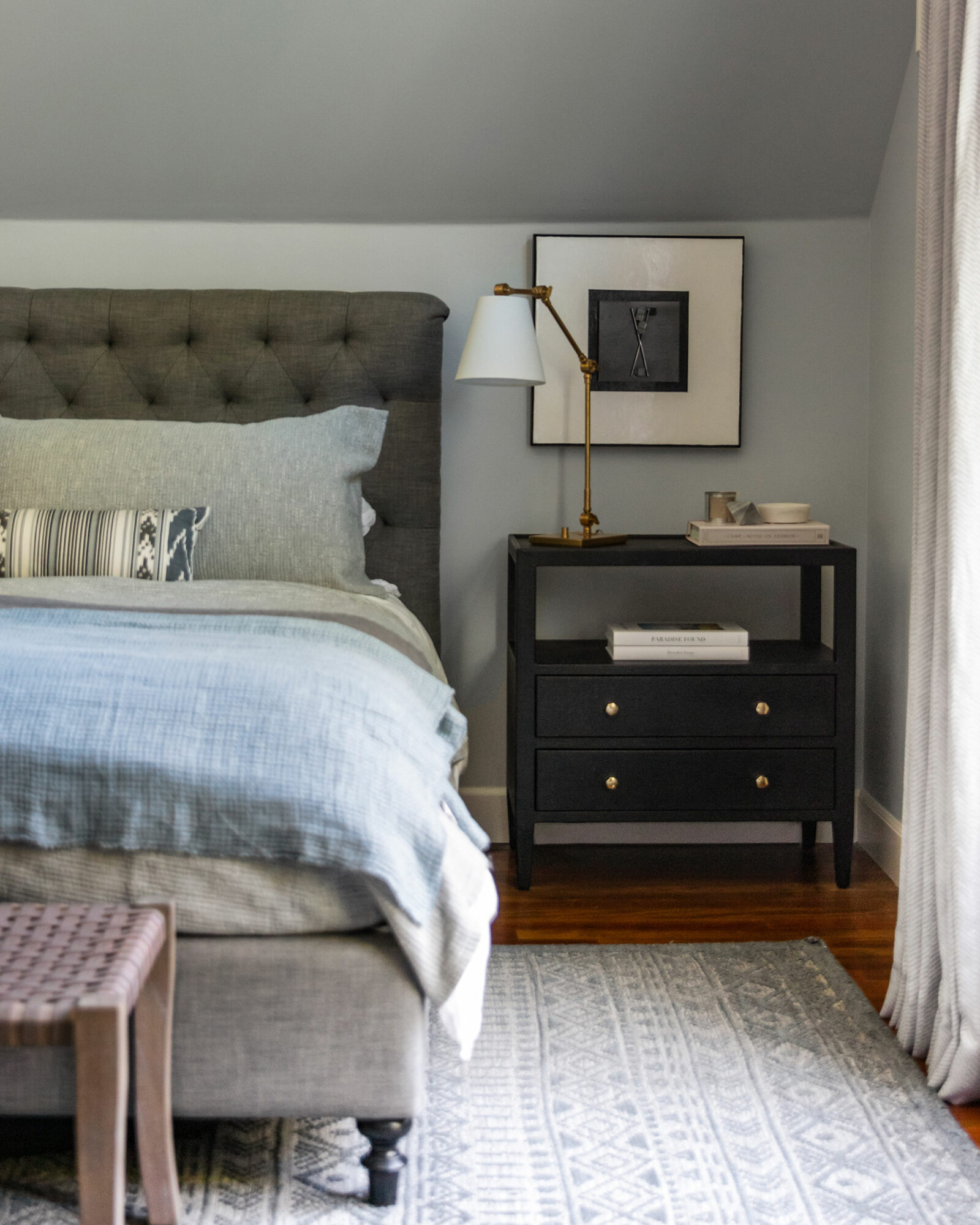 primary bedroom in Benjamin Moore Wickham Grey with bed, nighstand and swing lamp