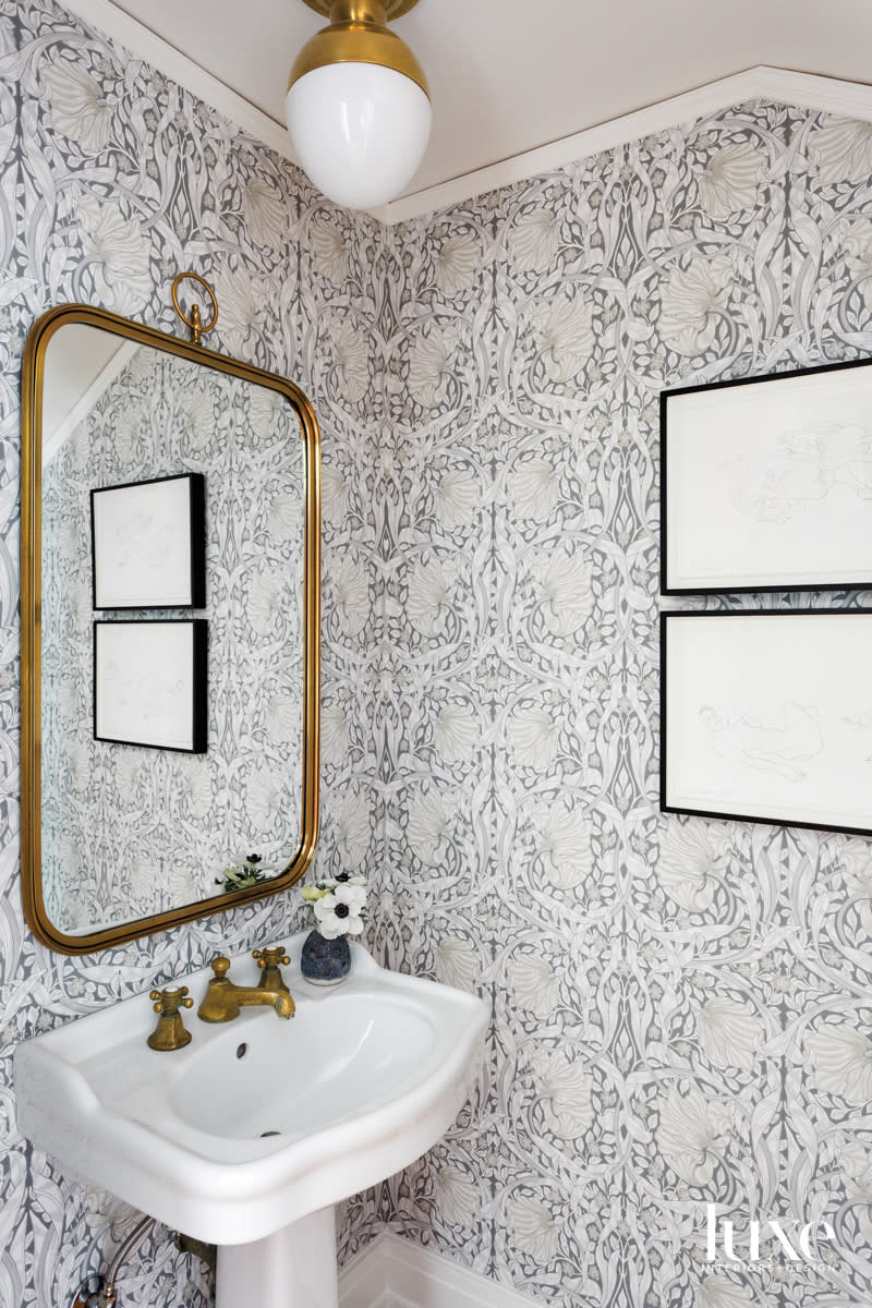 Small powder room with wallpaper and vintage sink