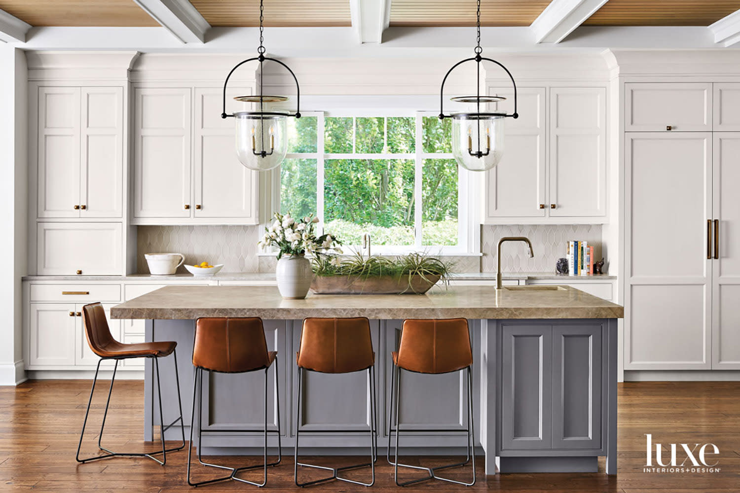 transitional gray kitchen island topped with tan quartz countertops
