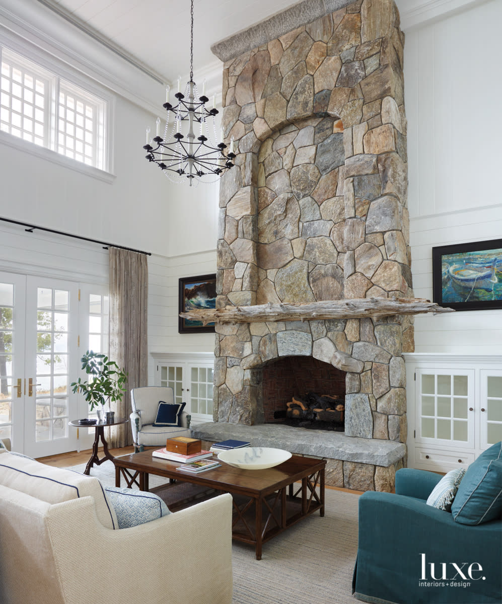 The great room features a large fieldstone fireplace.