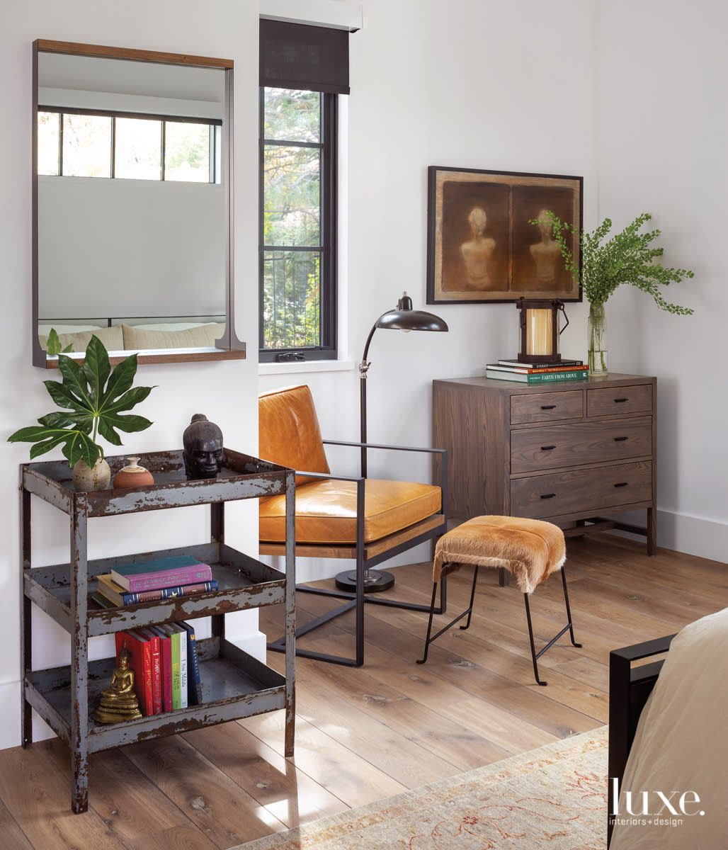 guest room corner with sitting area and lamop, table rack and chest
