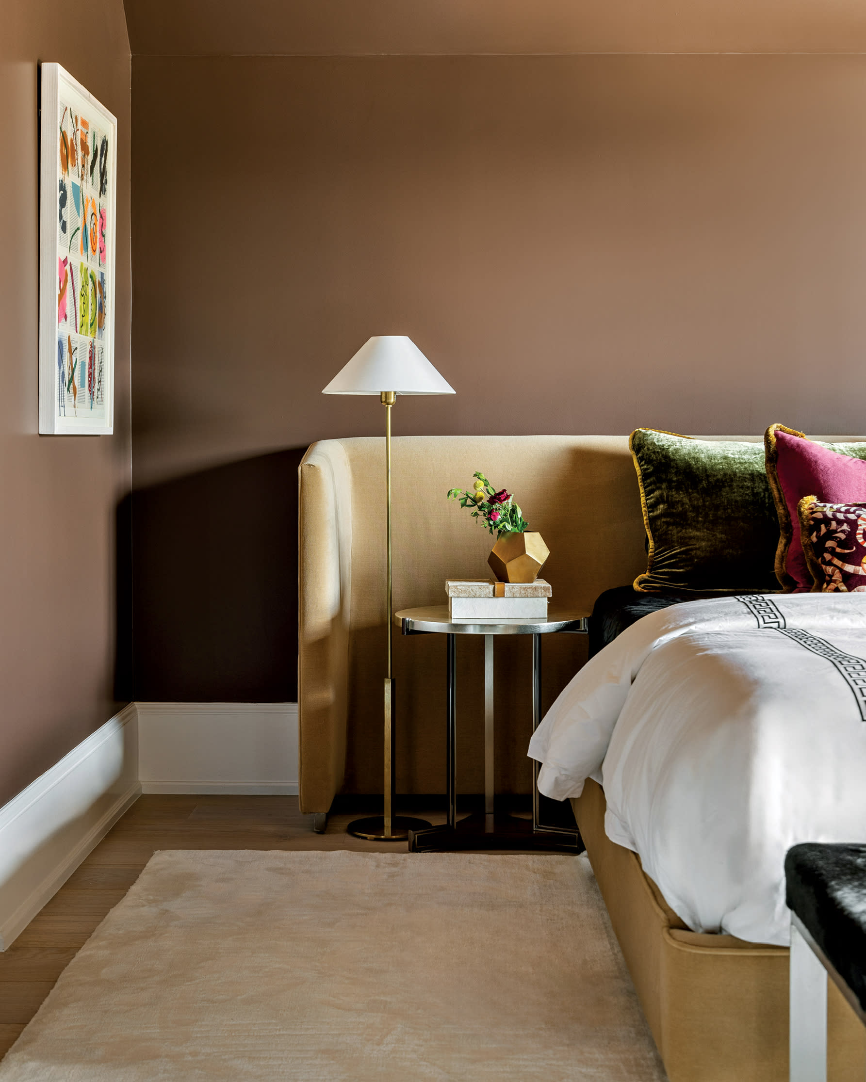 cozy guest bedroom with brown walls and a light yellow bed