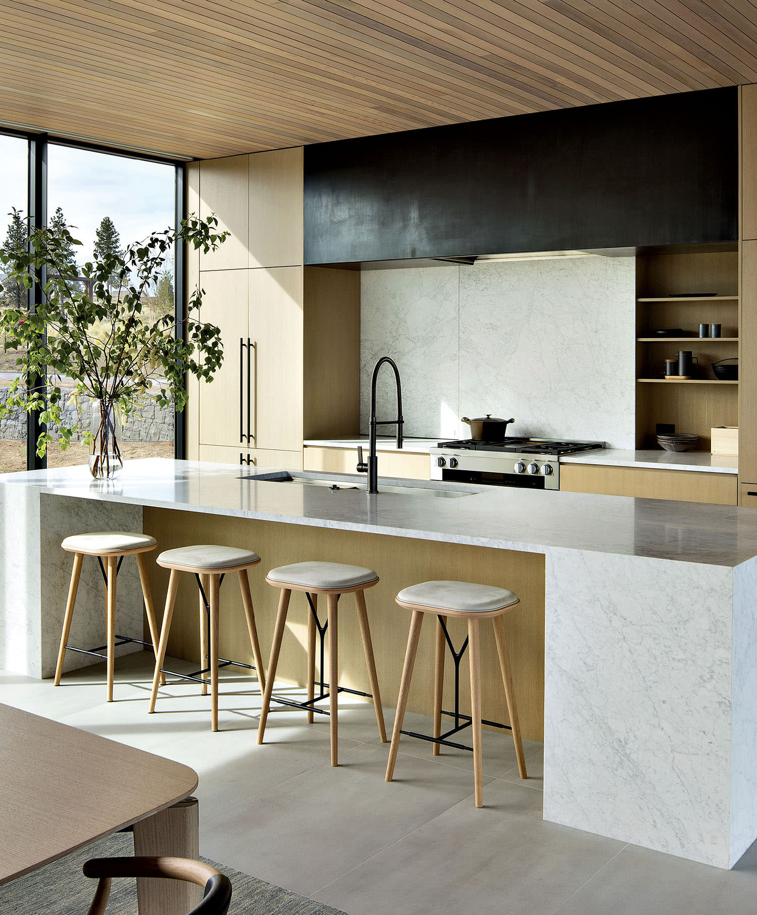 kitchen with rift-sawn white oak cabinets and a white marble countertop