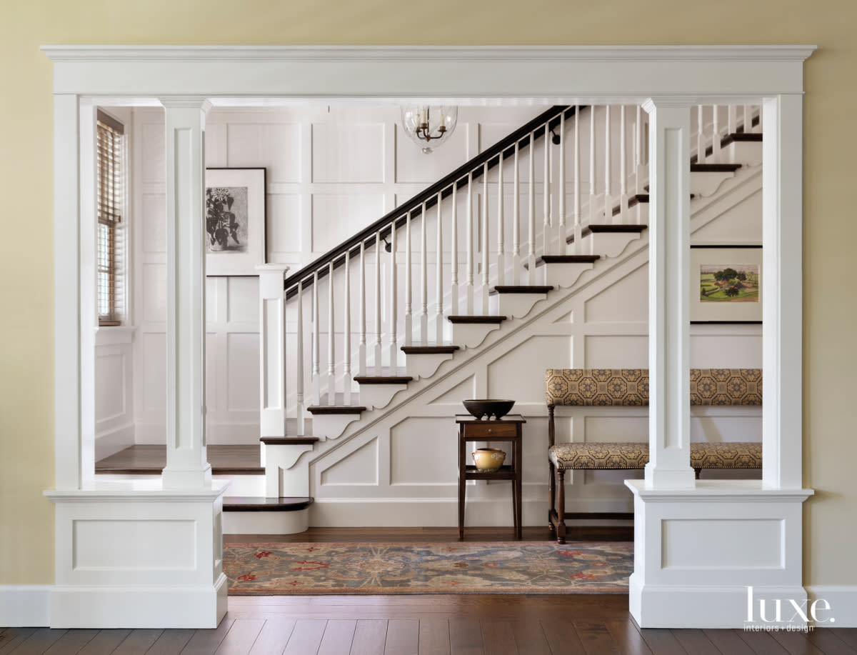 Entry hall with staircase, paneling and Louis XIII bench