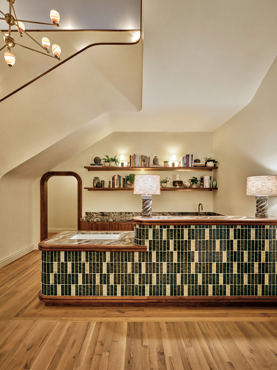 Bar area with stone countertops, wood accents and green-and-cream tiles.