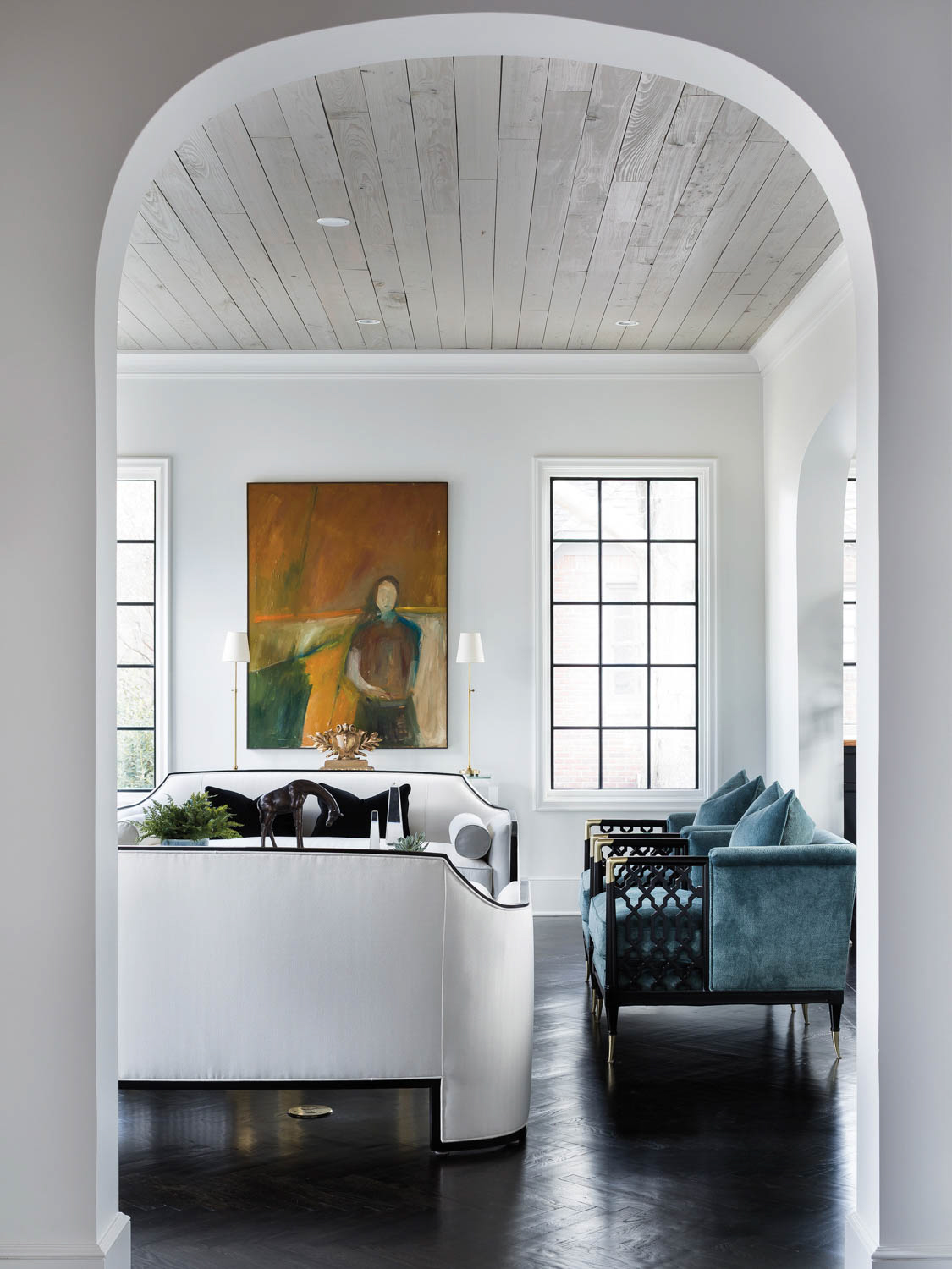 entry into a living area with blue sofa and white chair