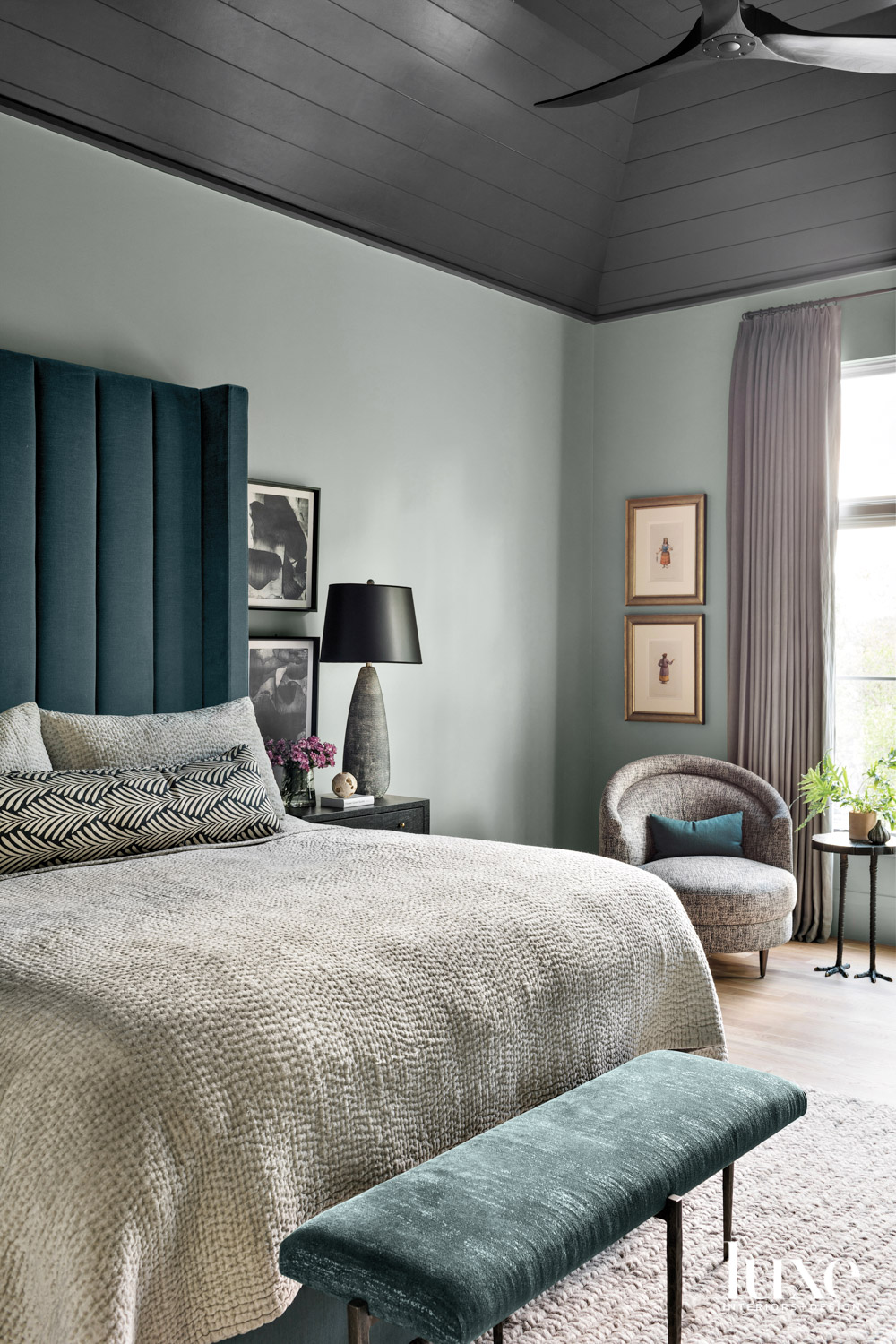 zen bedroom with sage-colored walls and dark teal headboard