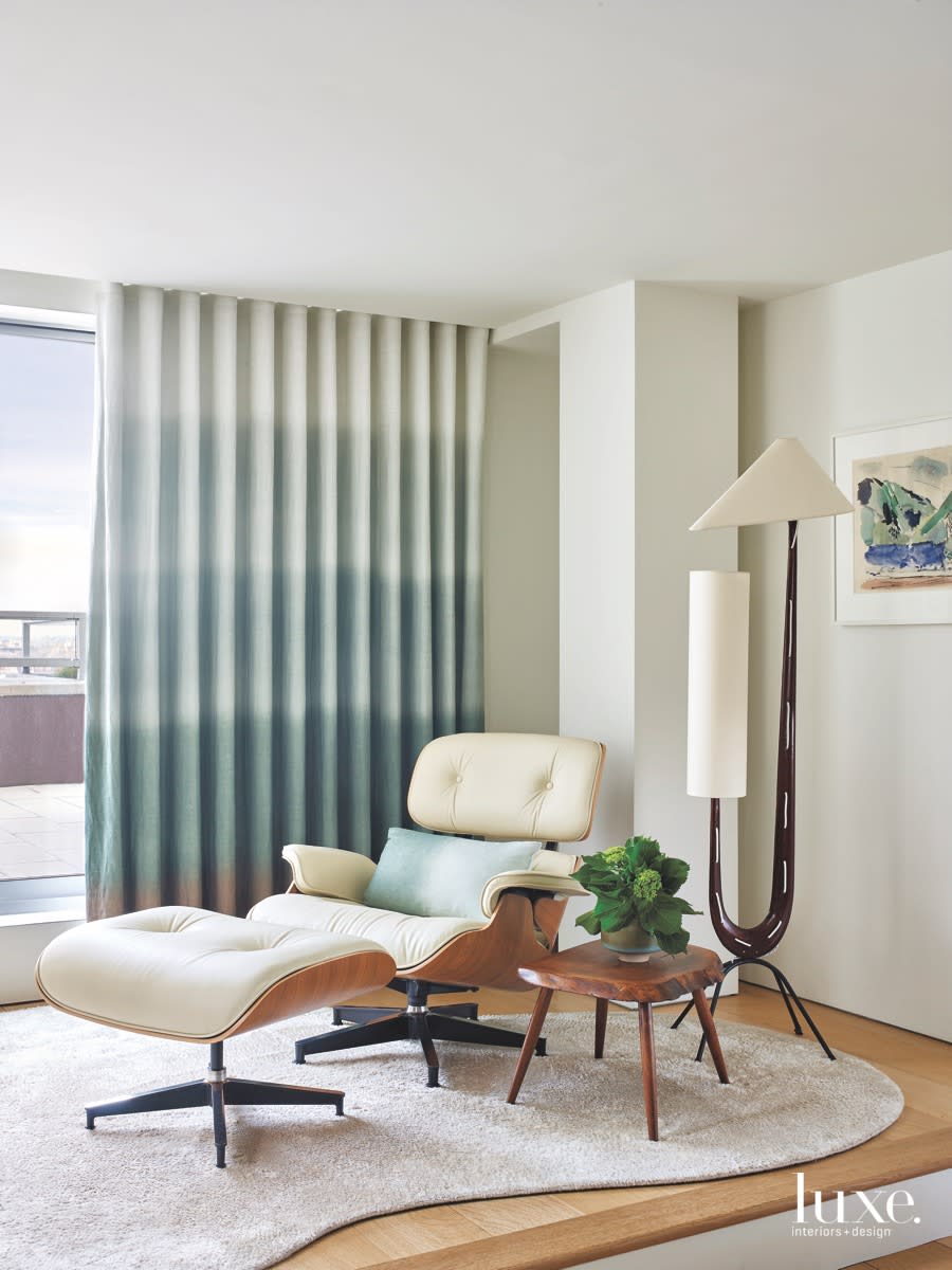 modern bedroom white lounge chair blue drapes