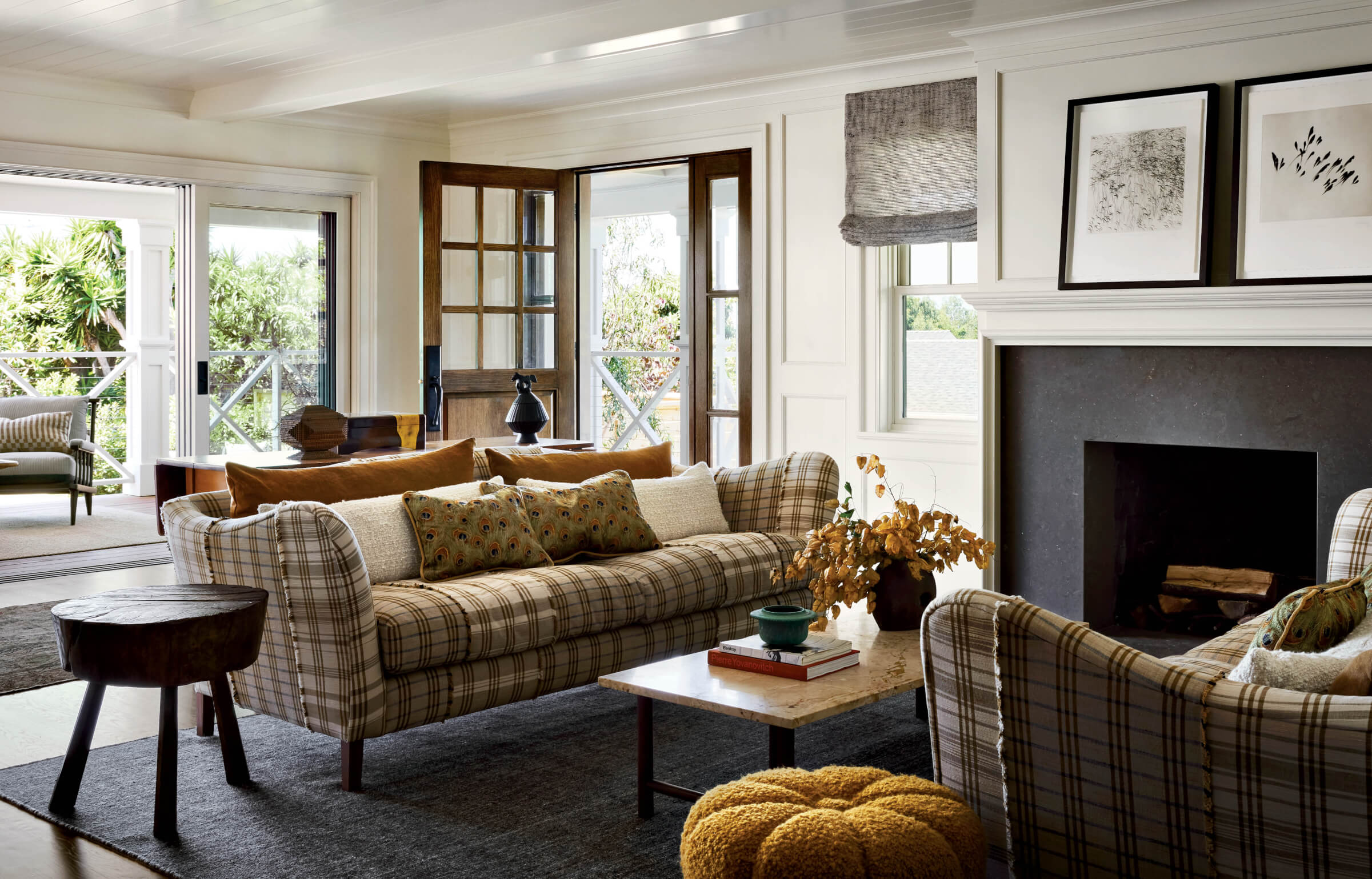 vintage-inspired living room with plaid sofas and marble-and-walnut coffee table